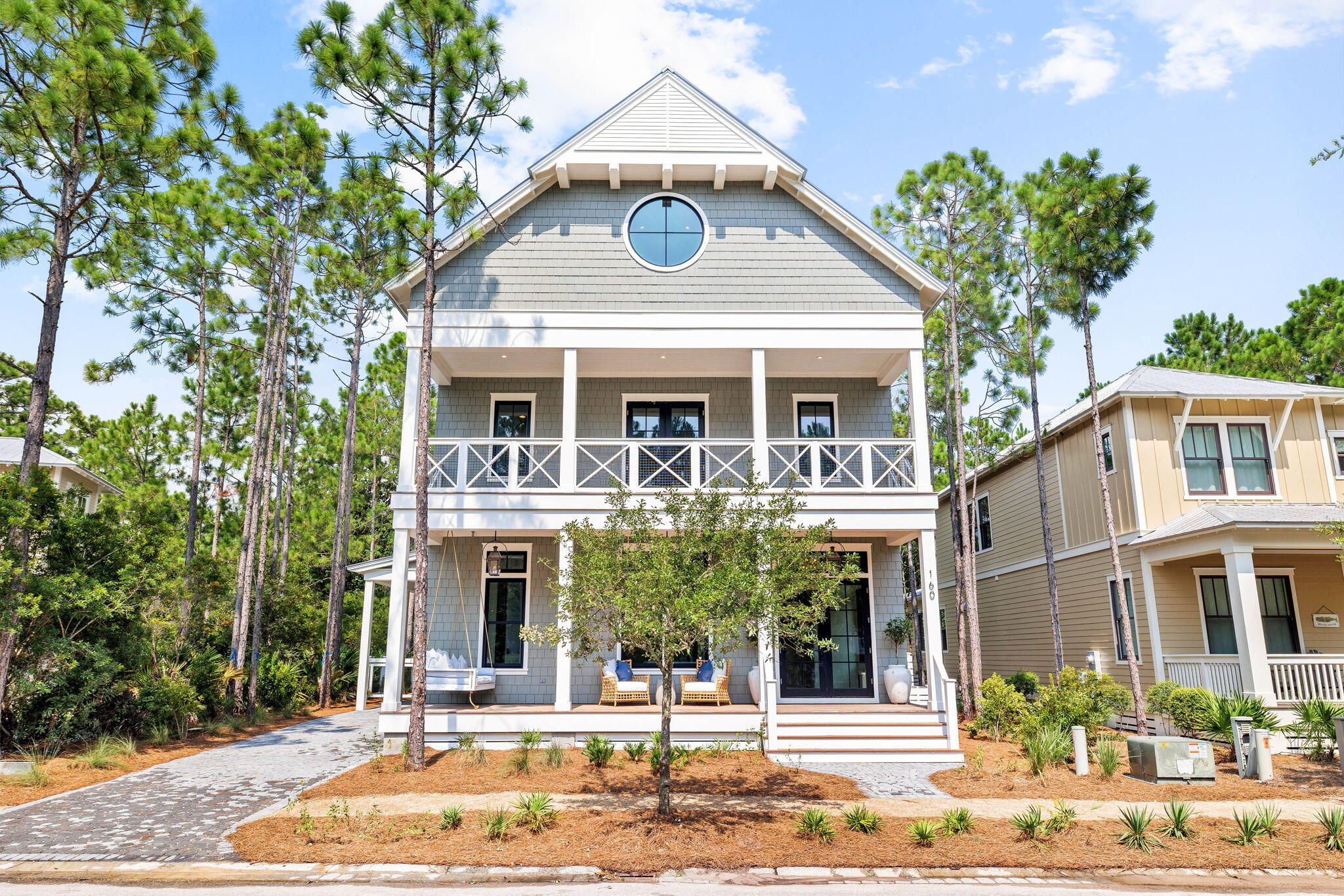 Framed by picturesque vegetation and prominently positioned within the Forest District of Watercolor, this impressive new construction opportunity, aptly coined Maison De Blue, embodies the epitome of luxury coastal living along 30A. Executed by the renowned Coastal Elements building team and the skilled design team at Q Interior Surfaces, this inimitable architectural masterpiece spans three levels with over 5,100 square feet of articulated living space. Upon initial approach, the spacious porch leads the way to the vaulted foyer with  French oak flooring carried throughout.