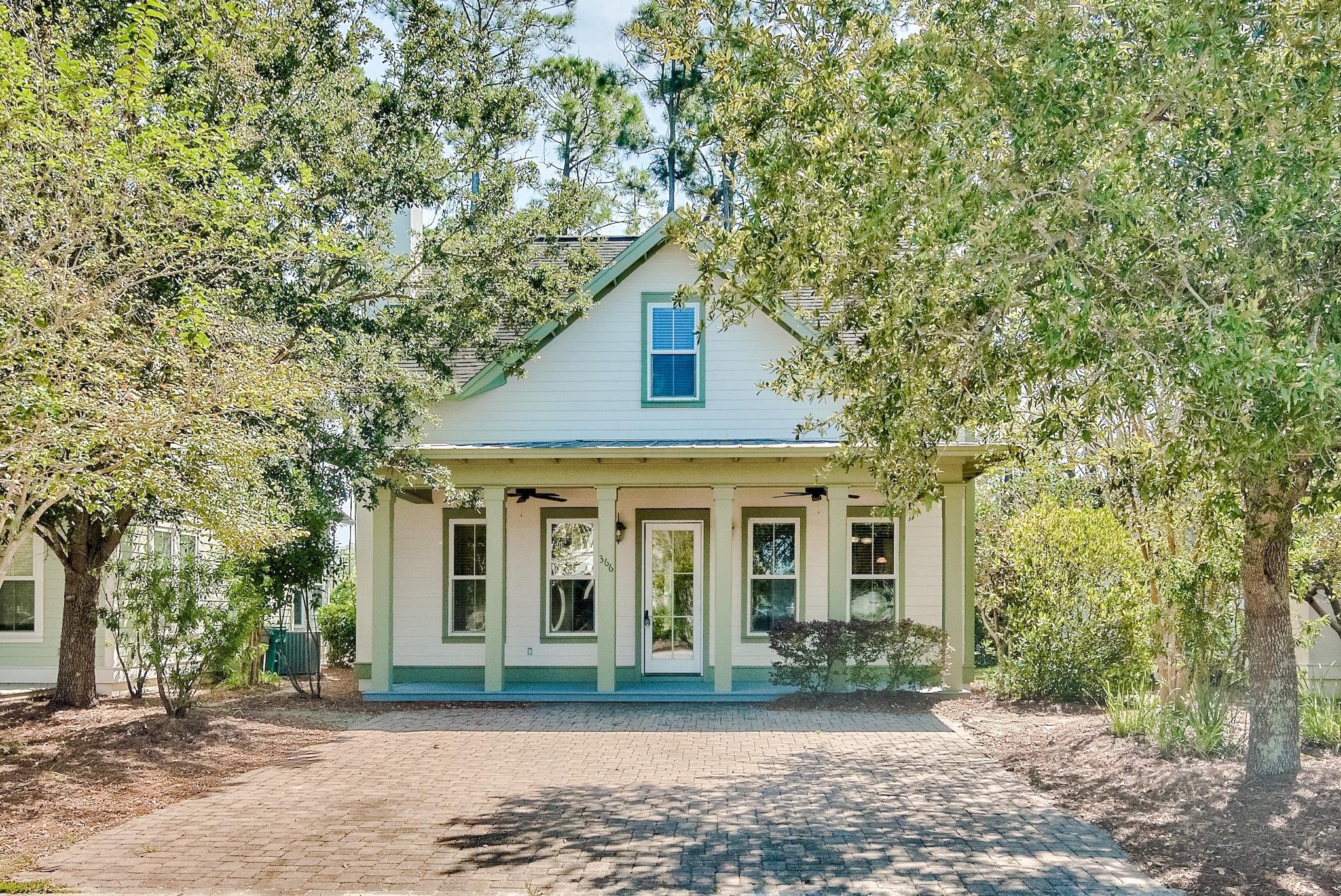 Beautiful 4-bedroom, 3.5-bath home in Harrison's Walk, a great community close to the beach. Incredible price for a generous home this close to the Gulf of Mexico! This home has great curb appeal with the covered front porch & paver stone driveway. Both the exterior and interior was freshly painted. Interior offers beautiful tile floors throughout the common areas, raised ceilings, and great natural light. Craftsmanship details like crown molding and white wainscoting give the property a beach cottage feel. This is a fantastic open floor plan with a ground floor master bedroom for added convenience and three guest bedrooms on the upper level. Great kitchen with chic wood cabinets, expansive granite countertops, and breakfast bar with custom lighting. All bathrooms feature granite as well!