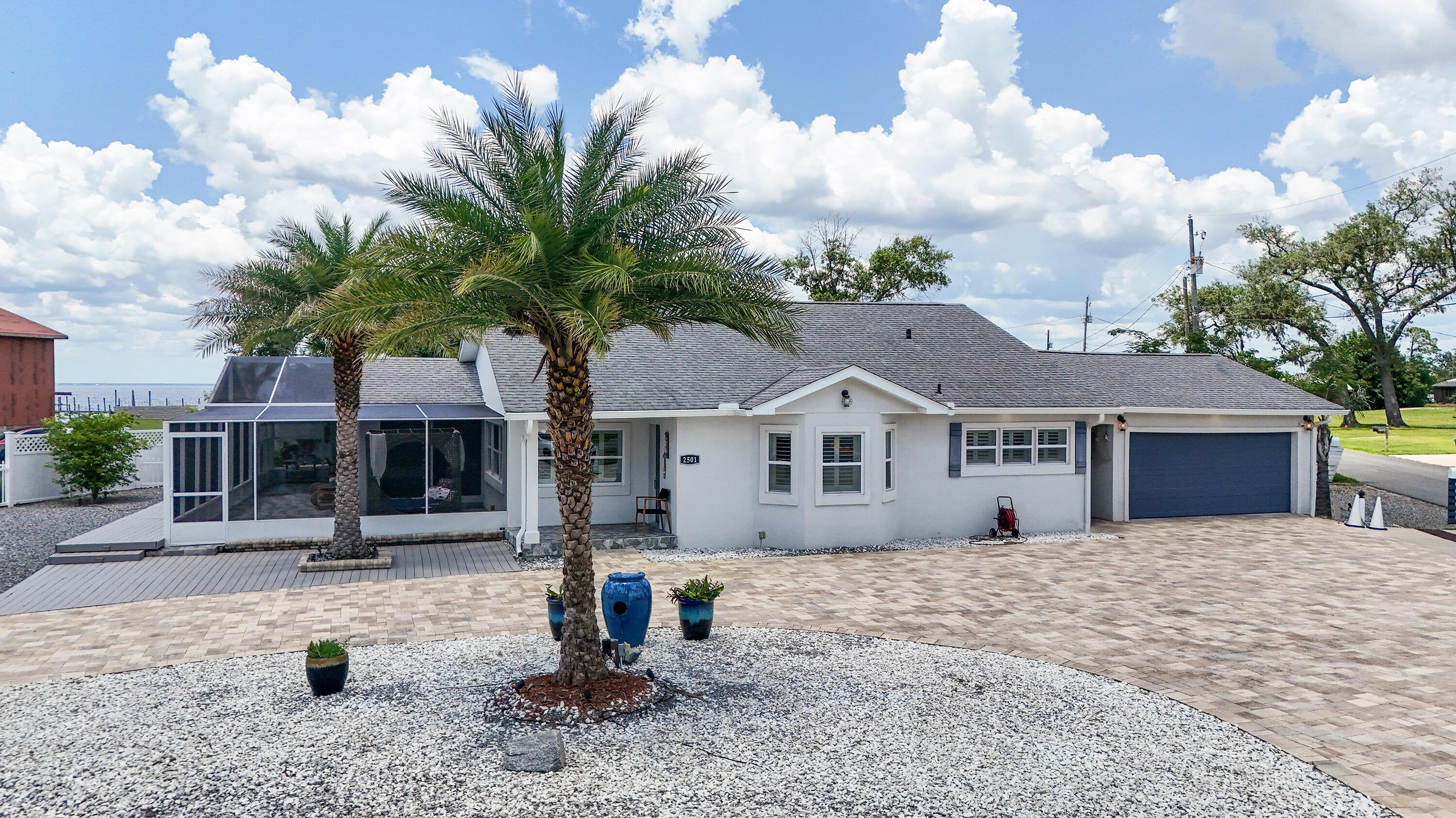 Step inside this coastal gem--no HOA, no fees, and short-term rentals are allowed! Just a short stroll from direct bay access, this charming 4-bedroom, 3-bath home blends modern upgrades with timeless coastal character. From the stucco exterior to the bright and airy interior, every detail has been thoughtfully curated for style, comfort, and function. The home is truly move-in ready, featuring double-pane windows, updated systems, and flowing layout. The gourmet kitchen impresses with stainless steel appliances, quartz countertops, a decorative backsplash, and upscale lighting that elevates every meal. All three bathrooms have been tastefully renovated, and the spacious family room offers custom built-ins, a cozy fireplace, and a planked ceiling--perfect for relaxing or entertaining.