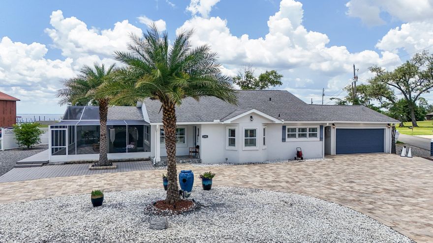 Step inside this coastal gem--no HOA, no fees, and short-term rentals are allowed! Just a short stroll from direct bay access, this charming 4-bedroom, 3-bath home blends modern upgrades with timeless coastal character. From the stucco exterior to the bright and airy interior, every detail has been thoughtfully curated for style, comfort, and function. The home is truly move-in ready, featuring double-pane windows, updated systems, and flowing layout. The gourmet kitchen impresses with stainless steel appliances, quartz countertops, a decorative backsplash, and upscale lighting that elevates every meal. All three bathrooms have been tastefully renovated, and the spacious family room offers custom built-ins, a cozy fireplace, and a planked ceiling--perfect for relaxing or entertaining.