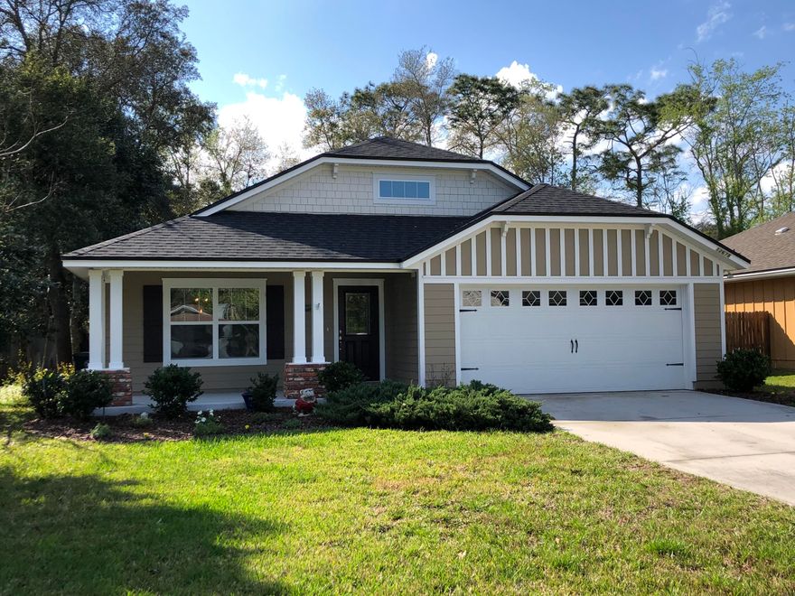 OPEN floor plan! Premium wood laminate flooring in all rooms except bathrooms & laundry which boast porcelain tile. SS Appliances in kitchen w/ French Door BOSCH dishwasher, granite counter tops, large prep island, glass tile back splash & custom pendant lighting! Bathrooms have raised vanities, framed mirrors & tiled surrounds. Artesian well & septic system Covered, screened lanai. Large, 2-car attached garage, security system. Pentair Water Softener. Just minutes from the convenience of Bartram shopping & dining.