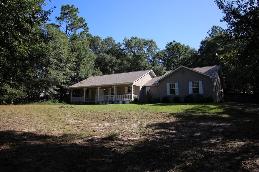 COMPLETELY REMODELED 4 BED 3 BATH FIREPLACE HOME  READY TO MOVE IN!!! With New 30yr Warranty Dimensional Shingle Roof, New Paint Inside & Out, New Granite Countertops, New Stainless Steel Appliances, New Laminate Floors, New Carpeting, New Lighting & Fans, New Bathrooms, Wood Burning Fireplace, Peaceful Wooded 1 Acre+ Yard and more  there is no honey do list, just move in and relax. Two master suites! The garage has been converted to a second master suite that is handicap accessible with a large walk-in shower with seat, a large walk-in closet, and its own exterior entry. The main master suite is large and includes a jacuzzi/garden tub, separate walk-in shower, and a huge walk-in closet.