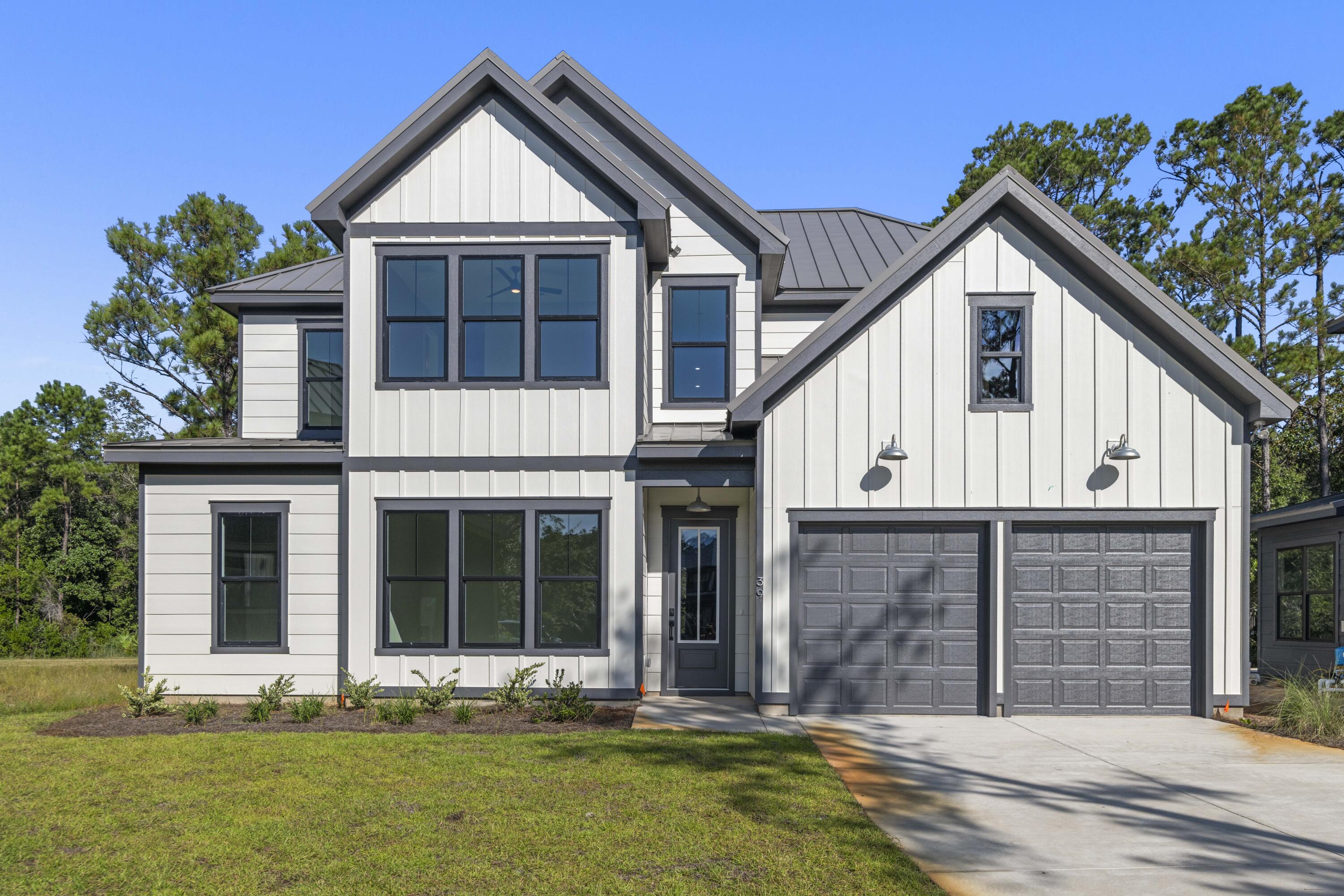 MOVE-IN READY !!! The Shoal - a peaceful neighborhood surrounded by natural beauty, this stunning residence features over 3,000 sq/ft of thoughtfully designed living space. Equipped with 5 spacious bedrooms and 4.5 elegant bathrooms, this home is ideal for families or those who love to entertain. High-end finishes and designer touches are found throughout. Enjoy the serenity of a private wooded backyard. Come see this brand new, low maintenance, end of the cul-de-sac home in one of the most desirable locations of Santa Rosa Beach, Point Washington. Shopping, groceries, schools and the beach are near by. Welcome to The Shoal, a brand-new neighborhood where tranquility meets convenience. Nestled on the fringes of the expansive Point Washington State Park, this community boasts 30 thoughtfully designed homesites, each strategically laid out to provide residents with a sense of privacy and a connection to nature. The Shoal is conveniently located a short drive to Seaside, Grayton Beach and 30a. These spacious homes are designed to harmonize with the unique esthetics of the area boasting earthy tones, a community pond, and half of the lots backing up to state park. The Trenton floor plan offers 5 bedrooms and 4.5 baths with an open living concept downstairs and a spacious loft area upstairs.
This home comes with amazing standard features such as a metal roof, impact windows/doors, quartz countertops, LVP floors throughout all of the common areas/bedrooms, 8 ft doors, and a gas range and vented hood in the kitchen just to name a few! Homeowners have the ability to choose their finishes and upgrades at their design appointment. Other notable upgrade options would be a free-standing tub in the master bath and a sunroom option downstairs. **Prices may vary based on upgrades and lot selection.** Photos are not of this exact home. Renderings show potential exterior paint color options**