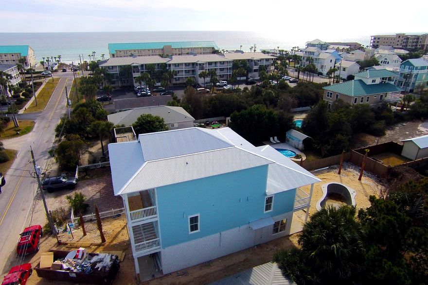 Charming new construction in Crystal Beach with excellent Gulf views from third floor Master and some views from 2nd floor. Just three houses from the Pompano beach access. This newly-built home will be finished right around 5/15/15, just in time for the summer rental season or for use as a primary or second home. Inviting pool area with lots of room for entertaining. Lovely large tile floor on first floor with attractive distressed driftwood flooring on stairs, second & third floors. Almost all bedrooms have a porch or balcony as well as an en suite bathroom. Samsung gas range. Gas pool heater. Well-thought out floor plan features one bedroom on first floor, four on 2nd floor, and Master on 3rd. Second floor also has a nice-sized 2nd living area or gaming area for kids.