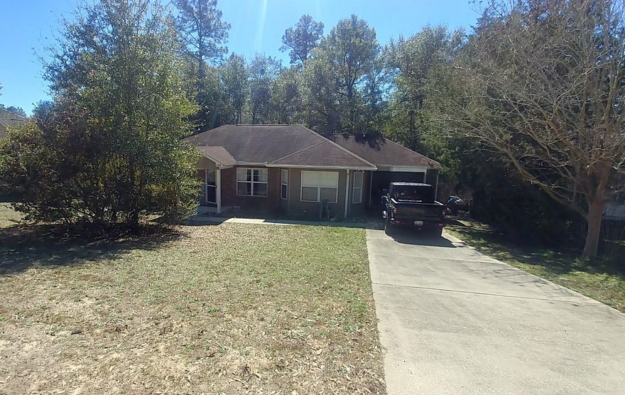 Wonderful 3/2 home with garage in great neighborhood.  Well-built with many custom features that you would find in the higher priced homes. Some of its hidden qualities are the cellulose insulation, also wired for security system. More obvious features include lots of natural light, lots of space.  Oak kitchen cabinetry, glass top range, dishwasher.  Ceramic tile in kitchen, dining, laundry, baths, inside and outside entries, backsplash in kitchen. Master bedroom has tray ceiling with special lighting, walk-in closet and bay window.  Brick front, vinyl siding for easy maintenance. French doors in dining room leading to wood deck overlooking large wooded lot. Home is located in a cul-de-sac so there is very little traffic.  This home has many extras you must see to appreciate.