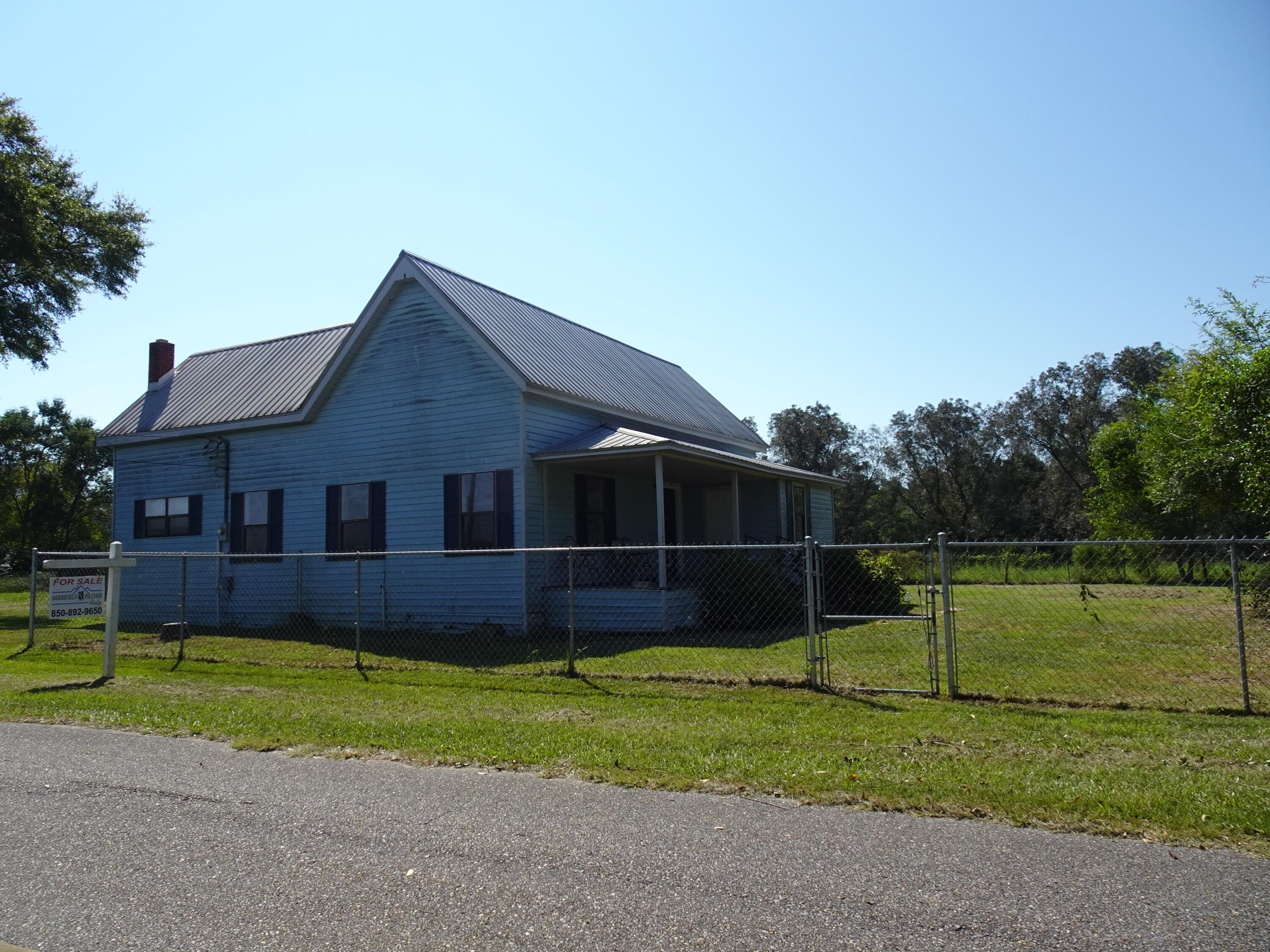 Looking for an amazing piece of property located close to town, this 9 acre parcel sits on a paved road and offers an older farmhouse converted to a 1BR / 1 BA but could easily be transported back to accommodate your family or made into your perfect starter home, getaway, or retirement place! Property fronts on a paved road, has pasture, an older barn, and a large pond in the rear of property. Property offers multiple pastures, tons of pecan trees, and the feel of the country just outside of town.