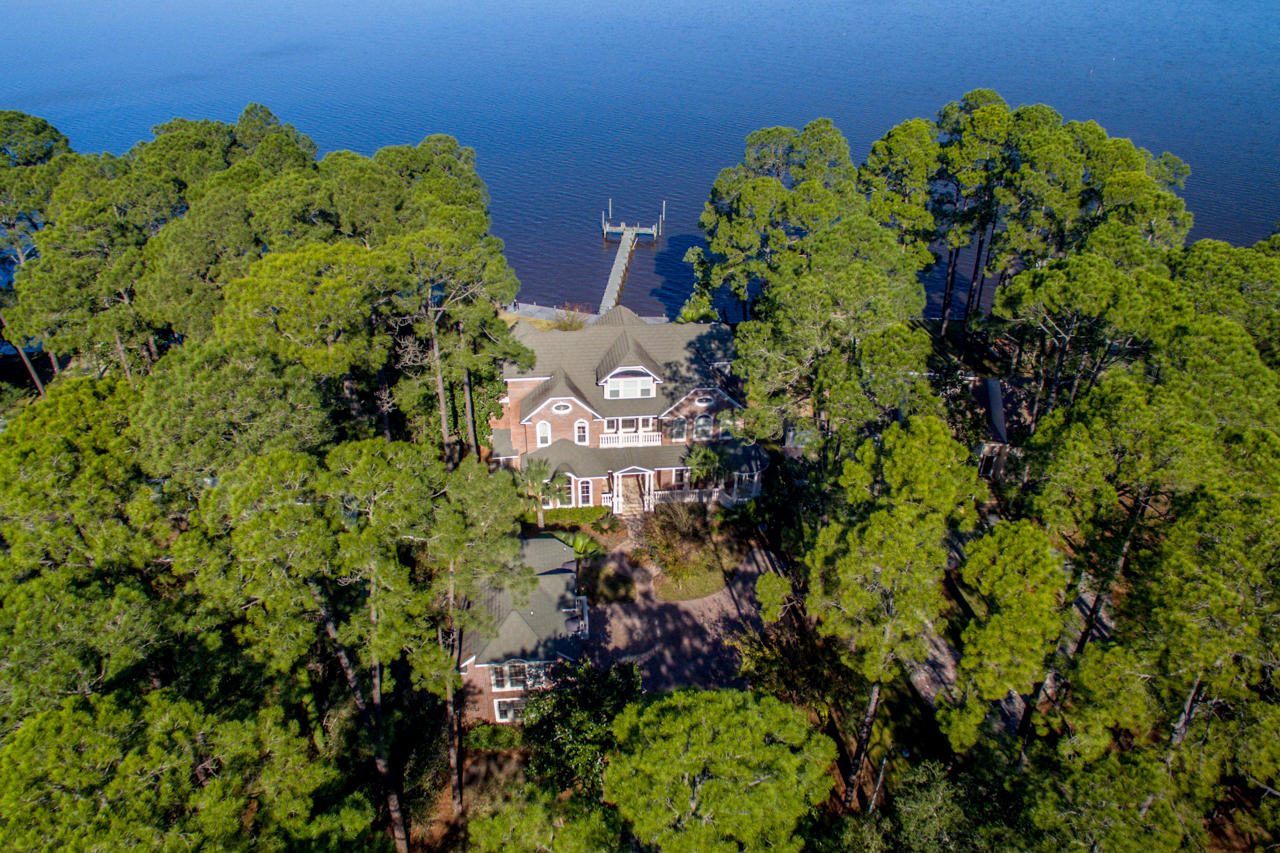 **PRICE JUST SHARPLY REDUCED**BANK-OWNED** This beautiful property includes an elegant 3-story main home, which combines gracious traditional and Southern design elements with comfort and convenience; a 3-car garage with carriage home; and a large, private lot on the Choctawhatchee Bay.The first floor includes a grand entrance, formal living room/parlor and beautiful formal dining room with a modern kitchen and attached family room. Highlights of the kitchen include large granite island, high-end stainless appliances, and custom cabinetry with abundant storage. The luxurious master wing and an exquisite formal office with separate entrance are also located on the first floor.An elevator joins all 3 floors, as does a rich Rosewood staircase with wainscoting...