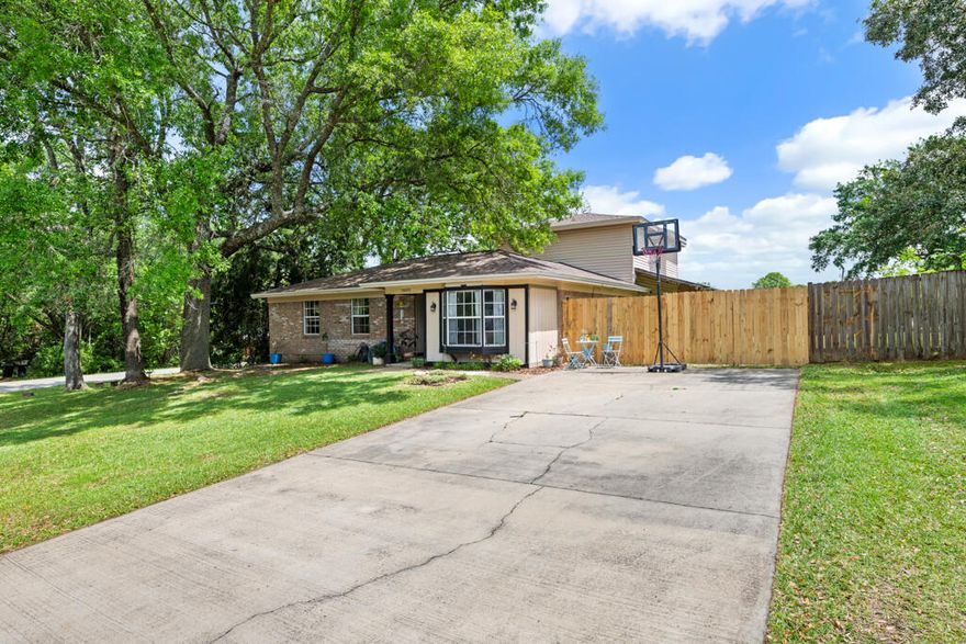 Welcome to this charming and unique 4 bedroom, 3 full bathroom home - situated on a generous sized corner lot in the Sharon Park subdivision, right along the Pensacola/Cantonment line. Just minutes away from shopping, restaurants, and just about 3 miles from I- 10 for quick commuting. Featuring a split floor plan, and a split level - with the primary bedroom with ensuite, sitting area, and walk-in closet at the back of the house on the second level. A cozy family room with a stone fireplace is also nestled at the back of the home with double doors off the side by the dining room to the wrap around covered patio in the backyard - the perfect spot to relax and unwind. The 3 additional bedrooms and bathrooms are found down a hallway just past the foyer by the kitchen. Out front, the driveway meets a double gate to the backyard - with no HOA and plenty of room for extra parking, an RV, boat, etc. Schedule your showing today!