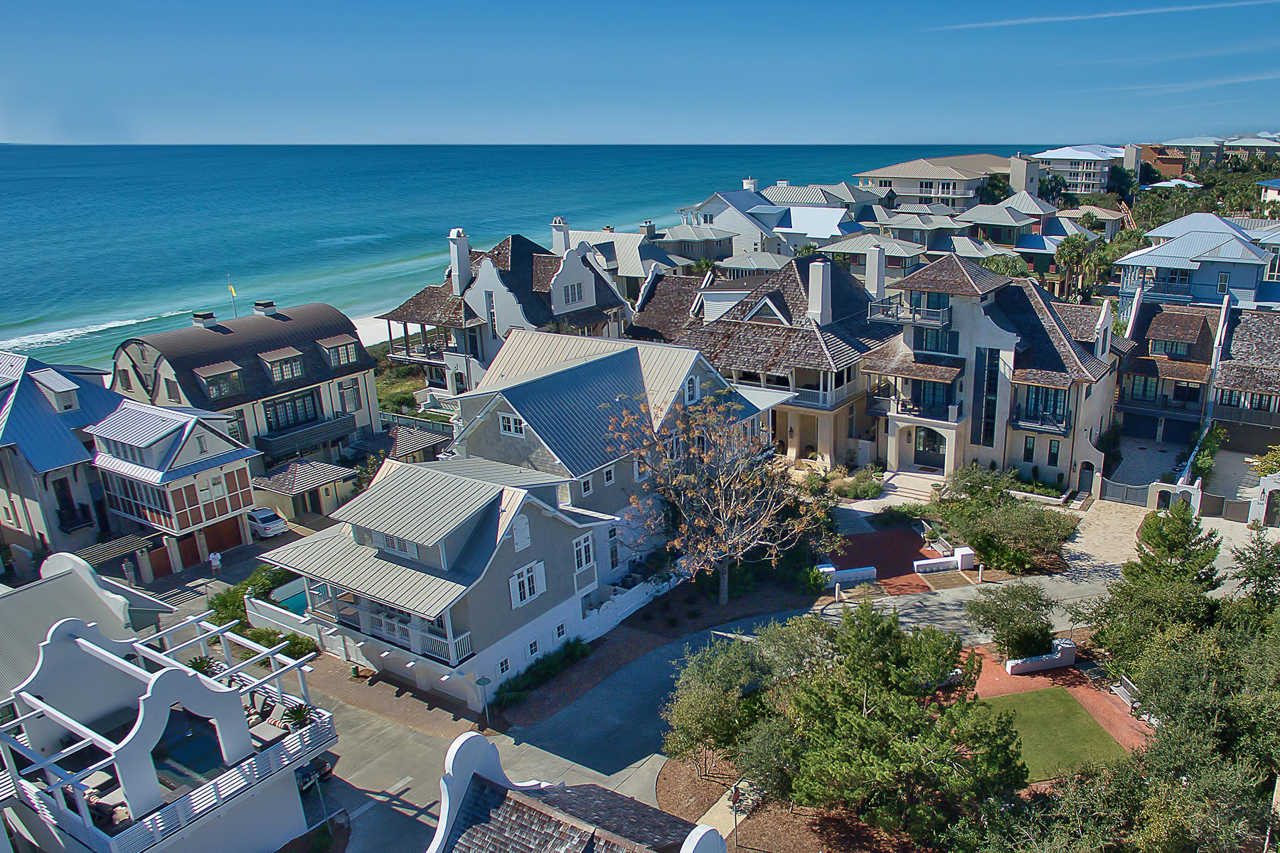 Just one off the gulf with direct gulf views, this double lot compound enclosed by masonry wall is truly a rare find in Rosemary Beach.This 'Cape Cod Grey and White' iconic landmark at the West Water Street curve impressively stands out. With no direct bordering neighbors on all four sides, this estate compound comprises seven bedrooms with three master suites for a total of 20 guests.Expansive porches and balconies of over 1500 square feet open onto the sounds of waves and crisp gulf air. The enticing courtyard pool anchors your property.The second floor living room, with vaulted ceilings, is positioned to capture an abundance of light. A vibrant kitchen features new quartz countertops and lovely gray backsplash.