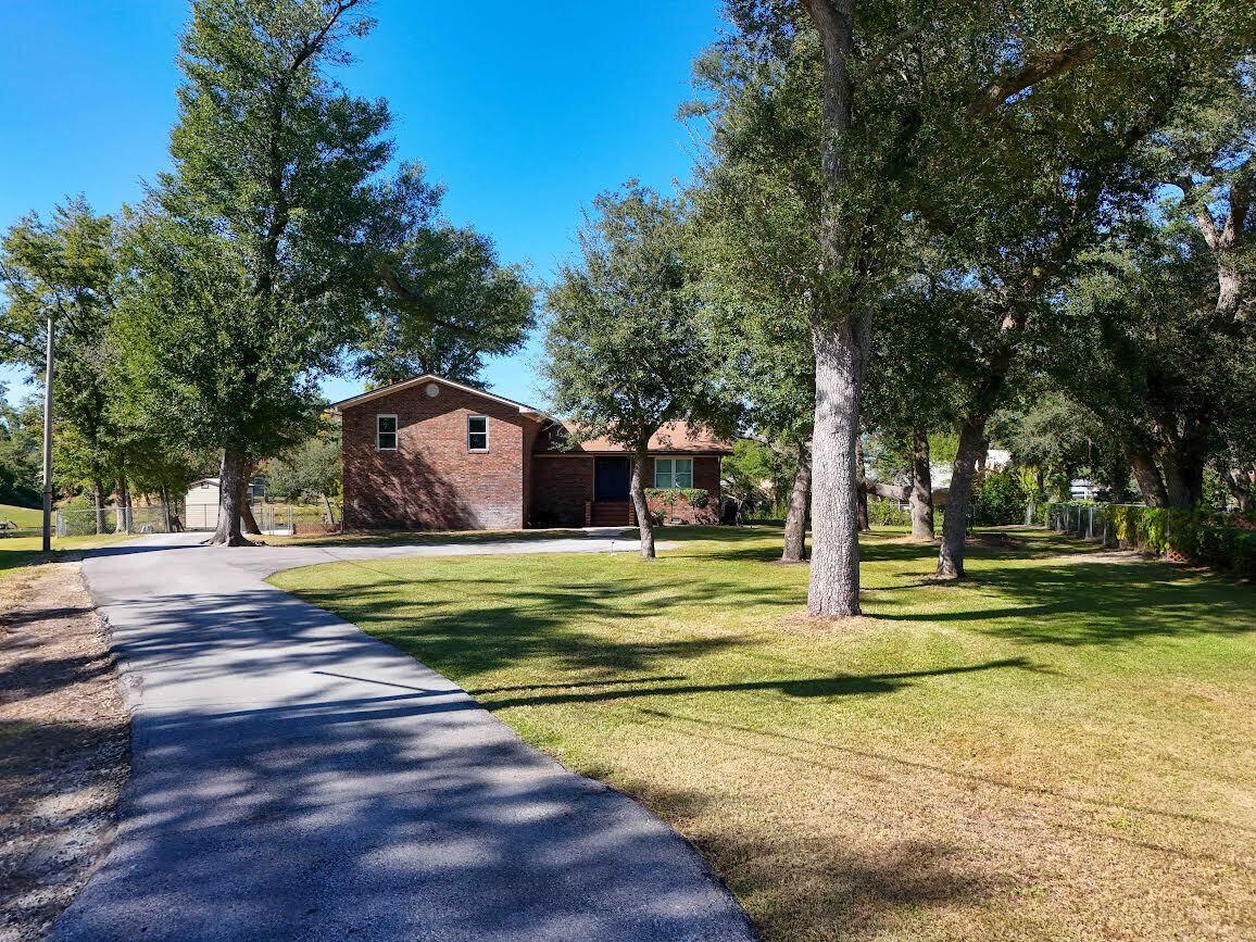 Waterfront living awaits at 4403 Bluewater Drive. Completely remodeled brick home with breathtaking lake views in the serene Deerpoint Estates community of Panama City. This completely remodeled three-bedroom, three-bathroom home is situated on a spacious 0.82-acre lot at the end of a quiet cul-de-sac, offering a perfect blend of modern comfort and tranquil lakefront living. This property features an oversized two-car garage, a fenced yard with a firepit, and breathtaking lake views from multiple rooms, including the bedrooms. The home has been completely updated with new flooring throughout, all-new plumbing and fixtures, a new septic tank, and a roof installed in 2022. Two brand-new HVAC units, including ducting, registers, and returns, ensure year-round comfort. The kitchen is a standout with its modern design and smart features, including a Haier range, Moen smart faucet, LG over-the-range microwave, trash compactor, whole house water filter and softener, soft-close cabinets, and titanium leather countertops . The kitchen opens to the family room, creating an ideal space for entertaining. The bathrooms have been completely remodeled, and the home also features new double-hung windows, interior and exterior doors, and a newly rebuilt balcony. Deerpoint Estates offers a peaceful retreat with opportunities for fishing, boating, skiing, and wildlife watching. The sunsets and sunrises are nothing short of spectacular, making this property a perfect escape. This home is truly turn-key and ready for its next owner. Don't miss this opportunity to experience the ultimate lakefront lifestyle. Schedule your tour today!