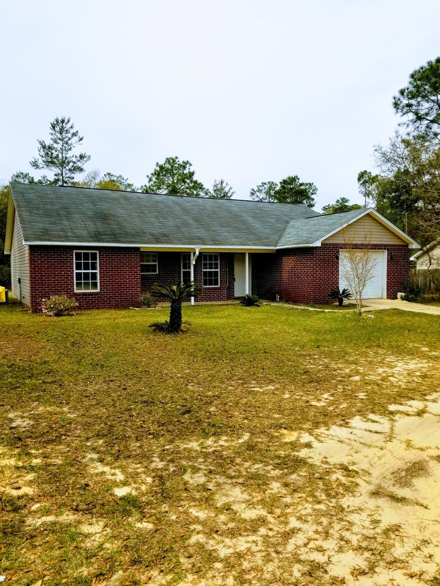 Open floor plan with vaulted ceilings, Kitchen/Dining area. Master suite with full bathroom. 2 bedrooms and full bath off Living area. Tile floors throughout, inside laundry room off garage. Flat lot with 1 car garage. House needs some TLC but would make a great home.