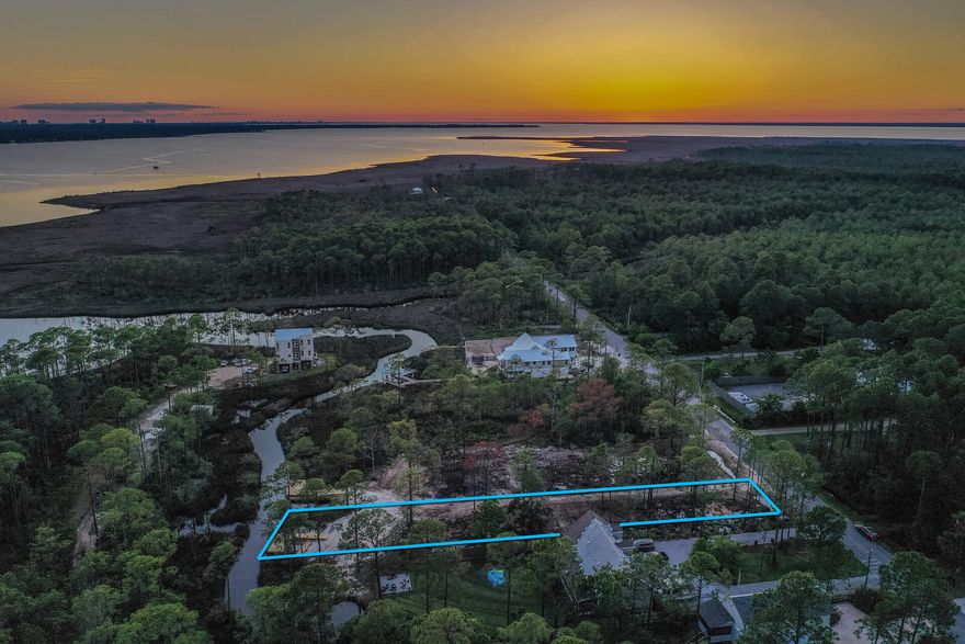 Bring your boat. This canal front lot offers immediate access to the bay. enjoy spacious water front living on this 75x303 foot lot. The lot is build ready with a survey, driveway, culvert installed, brushcut and has a dock. The lot has plans and will allow for a carriage house. No hoa or buildout time. Less than a one minute boat ride to Cesna landing and only a 4 mile ride to the beach. The lots are centrally located between Pier Park and Destin Commons