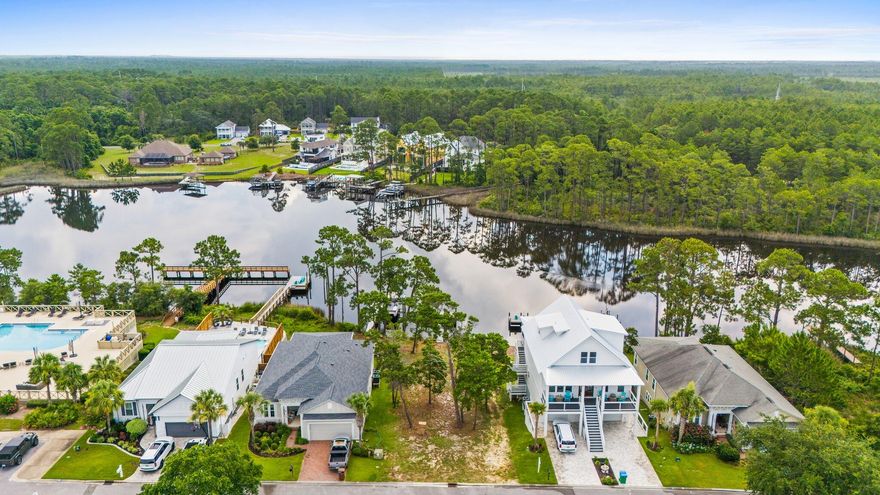 Tucked away in the serene, community of Turtle Cove at Lake Powell, this prime waterfront lot offers a rare opportunity to build your dream home in one of Florida's most peaceful and picturesque settings. With direct access to Lake Powell, Florida's largest coastal dune lake, this property includes community dock access, making it perfect for kayaking, paddleboarding, or simply soaking in sunset views from the water. Spanning nearly 8,300 square feet, the lot provides ample space to design a custom retreat with room for outdoor living and panoramic water views. Mature trees lend privacy and natural charm, while the tranquil cul-de-sac location ensures peace and quiet. Enjoy upscale amenities like a resort-style clubhouse, pool, fitness center, and tennis courts, all just minutes from the sugar-white sands of Panama City Beach and the charm of 30A. Whether you envision a cozy lakeside cottage or a spacious modern escape, this property is ready to bring your coastal vision to life. Waterfront lots with this kind of access and setting are few and far betweendon't miss your chance to claim a piece of paradise.