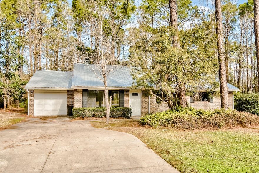 Incredible one level, 3-bedroom brick home in Santa Rosa Beach on over 1/2 acre. This is a convenient location just down from Louis Louis restaurant with easy access to the Bay and the beach! The home has been fully renovated and is turn key. Enjoy brand new flooring, updated kitchen with Quartz countertops and stainless steel appliances, upscale bathrooms with beautiful custom tile work, fresh paint, updated lighting and new AC. Vaulted ceilings and large windows allow the space to feel open. There is a great back porch and expansive backyard with plentiful foliage for a serene atmosphere. This is a rare find!
