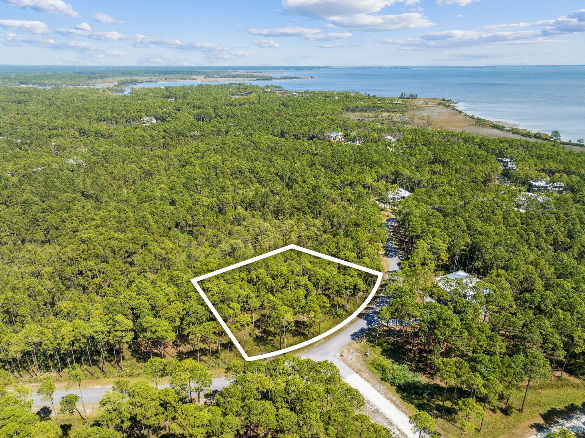 Tucked inside the private, gated community of RiverCamps, this .61-acre homesite sits on a paved road just a quarter mile from West Bay--perfect for catching those refreshing coastal breezes.RiverCamps is a unique hidden gem in Panama City Beach, designed as a nature preserve spread across 1,500 acres. With fewer than 450 homesites thoughtfully placed on 500 acres and the remaining 1,000 acres dedicated to conservation, it's a haven for outdoor enthusiasts. Residents enjoy 7 miles of scenic trails for hiking, biking, and wildlife watching, as well as direct access to West Bay, Crooked Creek, and the Intracoastal Waterway.The community offers a private boat ramp and dry storage, making it easy to launch your boat and reach Shell Island or the Gulf in about 30 minutes. Plus, you're just 10 miles from the sugar-white beaches of the Emerald Coast and a quick 10-minute drive to Northwest Florida Beaches International Airport.
With the brand-new pool and pavilion now open, RiverCamps blends convenience, privacy, and the ultimate outdoor lifestyle.