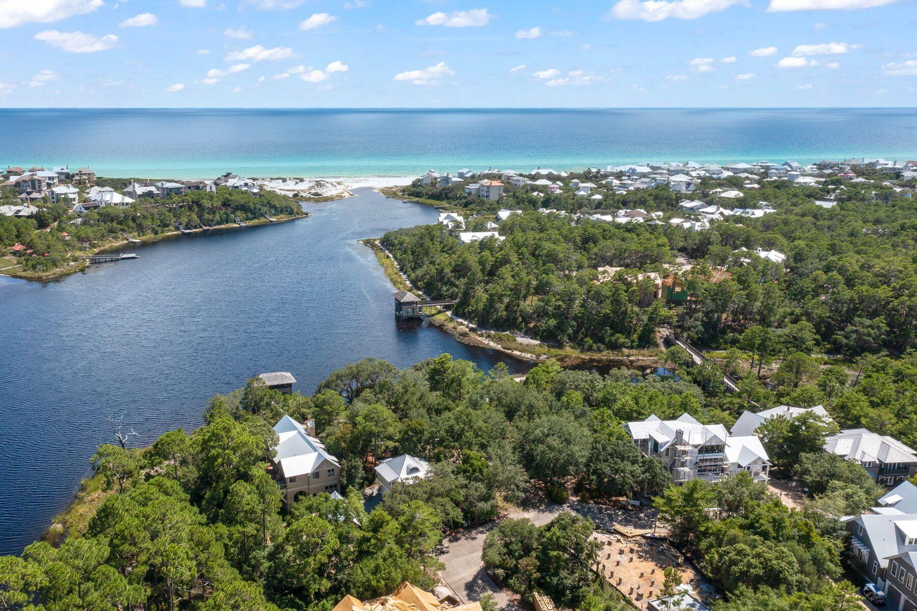 Located in the east peninsula of Draper Lake Coastal Village, this lakefront property sits adjacent to a scenic path tracing the shoreline of Draper Lake on its way to one of two community docks situated directly on the south side of the lot. With only one immediate neighbor, and buffered by the green area to the west, it offers exceptional privacy. Set so close to the dock, neighborhood amenities on either gated peninsula are within easy reach. Closest is one of two pools whose pavilions with outdoor fireplaces are appointed with comfortable, high quality outdoor furniture.