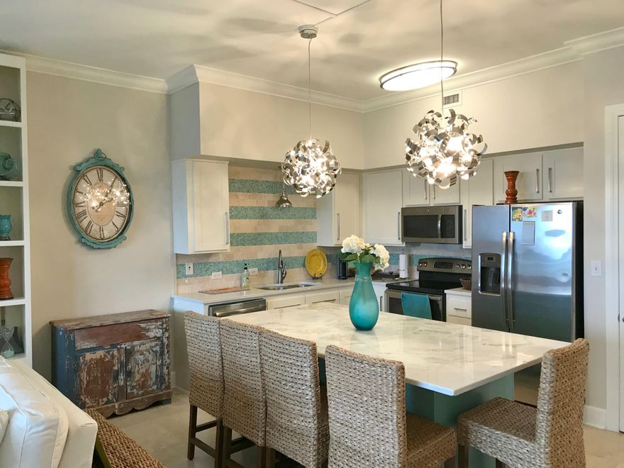 This immaculate updated 3 BR 3 bath condo is exactly what you're looking for & offers the best of both worlds! The sunset and intercostal views are absolutely breathtaking! This condo boasts elegant interiors with travertine flooring & hardwood tile throughout. Both guest bedrooms feature fully upgraded bathrooms. As you enter the open floorplan, you can find a wet bar with a wine cooler & additional cabinetry. The kitchen features unique quartz countertops, stainless steel appliances, beautiful backsplash throughout, & upgraded fixtures. The spacious balcony overlooking the beautiful lagoon pool & private beach on the intracoastal waterway makes perfect for relaxing & entertaining, with a private boat launch just steps away. The large private master bedroom has hardwood tile throughout, &