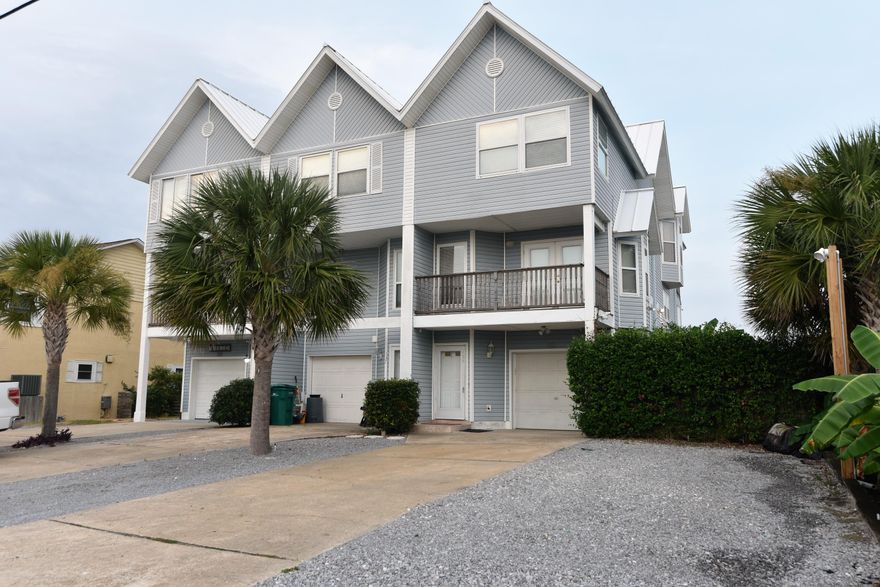 GREAT CANAL FRONT TOWNHOME ON HOLIDAY ISLE WITH LARGE BOAT SLIP!!! Boat slip can accommodate up to a 50' boat. MANY FEATURES INCLUDING: separate lockout apartment on 1st floor, 31' of prime waterfront, balconies & decks on all 3 stories, parking for 6 or more vehicles, 2 heat pump units, low maintenance metal roof, stainless appliances & granite in both kitchens, gas instant hot water heater, gas fireplace in master bedroom, two gas stoves, enclosed porches on 1st & 2nd floors, garage for storage or golf cart, lots of outdoor storage, and much more. House has a total of 3 bedrooms and 3 1/2 baths plus a bonus room on the 2nd floor that can be used as an office, guest room, etc. Great location directly off harbor with quick boat access to the Gulf of Mexico.