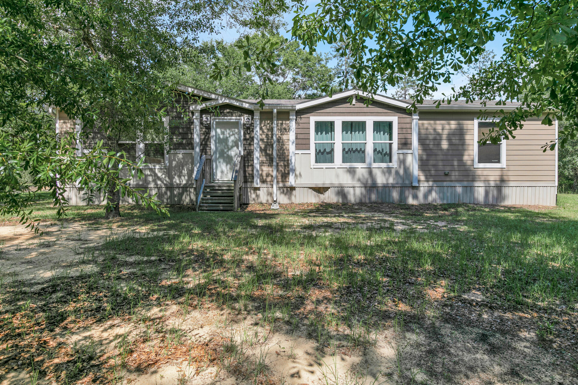 Walton Planation is a private community that provides hunting, fishing, relaxing and enjoying the outdoors that is well maintained. This property offers (13.6 acres, +/-) with a mobile home (2016) with a large screened in patio for observing nature and pole barn by the house. About 8 of the 13.6 acres are cleared. This includes 6900 original acres to include 145 privately owned parcels. You have access to a rustic open air chapel, public restrooms, ponds for fishing, a community garden, horse riding & ATV riding trails and approximately 300 yd. shooting range. Owners also have the option to join the hunting club for an additional $360 annual fee that allows hunting on approximately 2000 acres. Being sold unfurnished. Two parcels (Parcel 2,3) beside each other