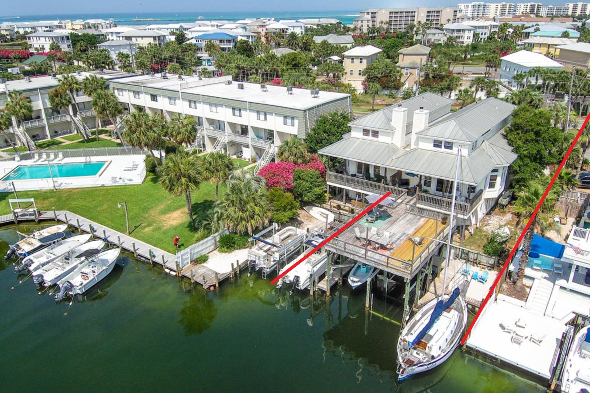 This home encompasses the true Destin life! Located on the tranquil canal waters of the Destin Harbor with your boats & water toys in your own backyard and just a short walk (0.4 mi) to deeded beach access. This 2,983 sq. ft. duplex lives like a traditional Holiday Isle residence with 40' of waterfront, three boat slips and large 25' x 20' deck (all new wood within 3 years old), perfect for entertaining or just relaxing the day away. There are 3 bedrooms, 2.5 baths in the main house with a separate waterfront efficiency apartment with full bath and kitchenette that is currently being operated as a successful Airbnb.