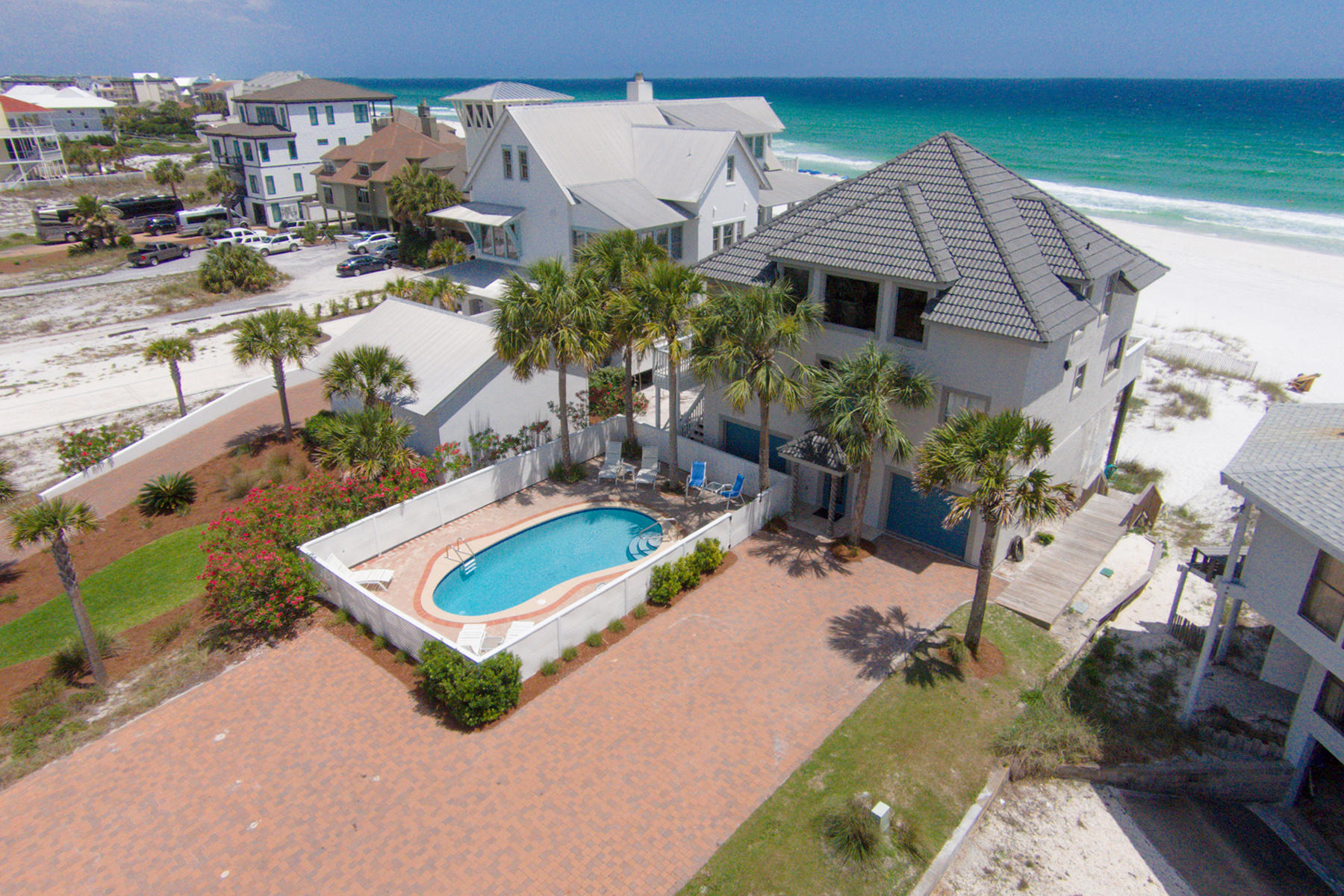 Situated between South Walton's historic coastal dune lake and the turquoise waters of the Gulf of Mexico, this gulf front home captures the essence of private island living without leaving the mainland. Measuring over half an acre, the lot stretches nearly 400 feet from low density San Roy Road to its 63 foot wide boundary along the mean high water line. Only five lots east of Eastern Lake's meandering outflow into the gulf, the beach is especially tranquil and rarely crowded. Rarer still are gulf front homes with private pools, and this home has quite a large one as well as abundant parking which contributes to its success as a vacation rental. A recently refreshed exterior gives way to open and inviting living spaces on the main floor with panoramic gulf views. An additional lake view loft living area upstairs gives everyone the freedom to spread out and express their beach dreams. Store your kayaks and paddle boards in the enclosed garage and launch them into Eastern Lake from the nearby county park with boat ramp, less than half a mile away, or directly into the Gulf of Mexico out your own back door.