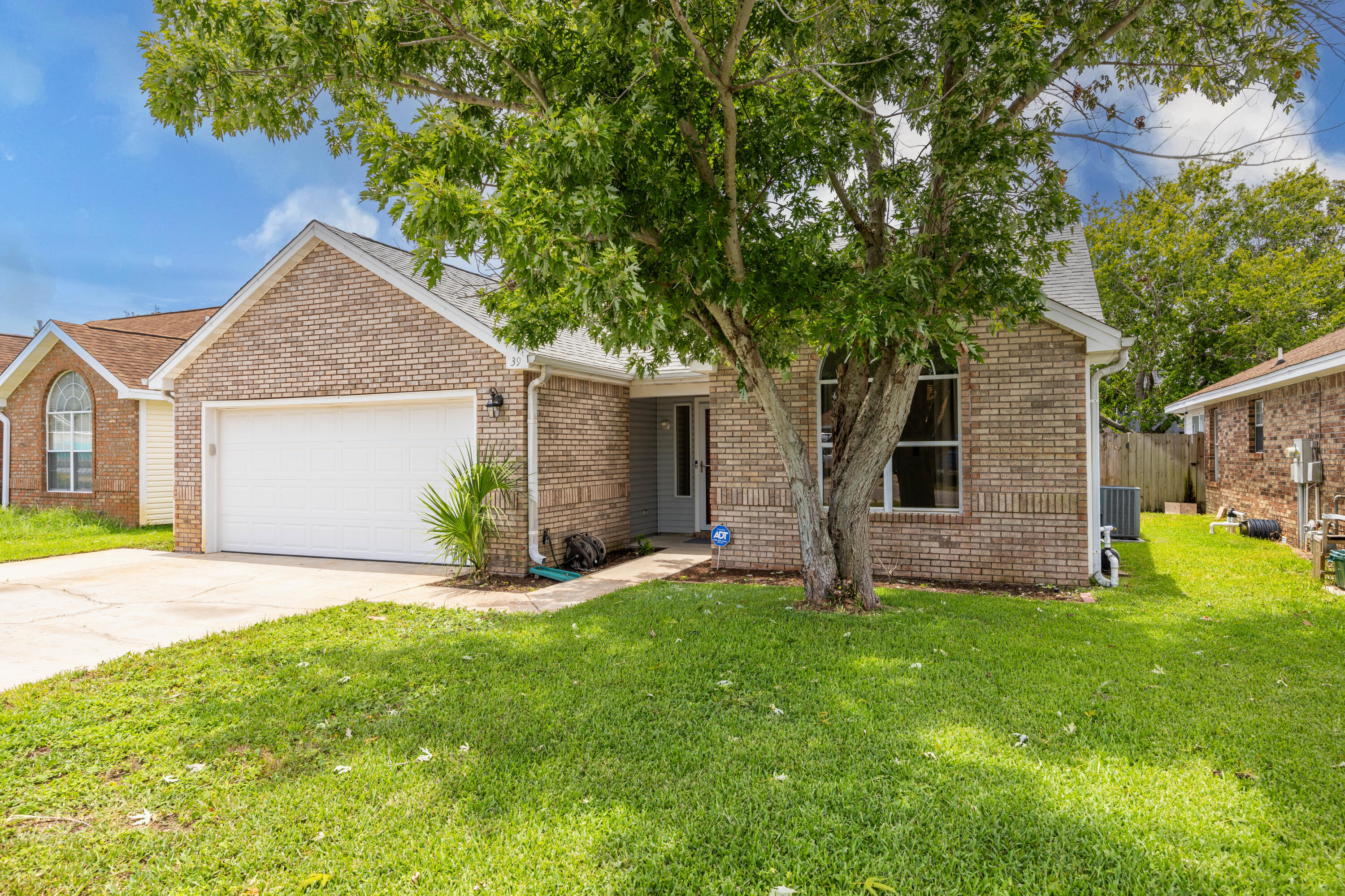 Nestled on a friendly street in the heart of Destin with no HOA, this inviting single-family home offers three cozy bedrooms and a host of charming features. Step inside this freshly painted home to discover a spacious, light-filled interior with a soaring vaulted ceiling that adds a touch of grandeur. The laminate flooring throughout lends a modern, yet cozy feel, setting the stage for stylish living. The split floor plan ensures privacy, while the tasteful updates provide the perfect canvas for your design dreams. Imagine creating your own oasis in the heart of this welcoming space! Outside, a two-car garage and extra-wide driveway offer ample parking, while an enclosed Florida room and covered back patio beckons you to relax and unwind.