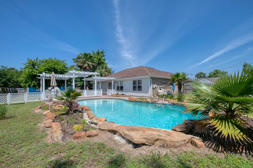 Less than 10 minutes to Navarre Beach, you will find your cul de sac dream home on a corner lot, featuring a gorgeous backyard with a fenced in pool with stone accents! Beautifully landscaped, this home also adorns a large covered patio - great for entertaining in the summer! Inside, an open floor plan, split bedrooms, and the master suite features a double vanity and tiled shower. Included in the eat in kitchen, are stainless steel appliances, a pantry, and a breakfast bar. Close to shopping, restaurants, great schools, and only 10 miles to Hurlbert!