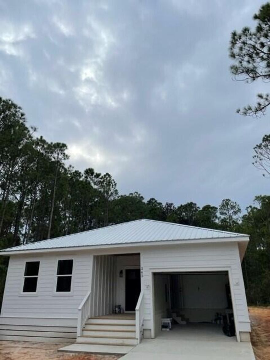 Almost Complete!  Now this feels like home! This amazing 3 bedroom floor plan has many special features.  First, when you walk through, you can sense how very SOLID this home is.  The high impact windows and doors throughout provide security from both weather AND unwanted guests.  All appliances, including the washer and dryer, are upgrades; insulation is more than required, and the finishes are excellent.  Outside, the 21+ x 10+' covered deck looks into a beautifully wooded area.  Watch for deer tracks in your backyard each morning!