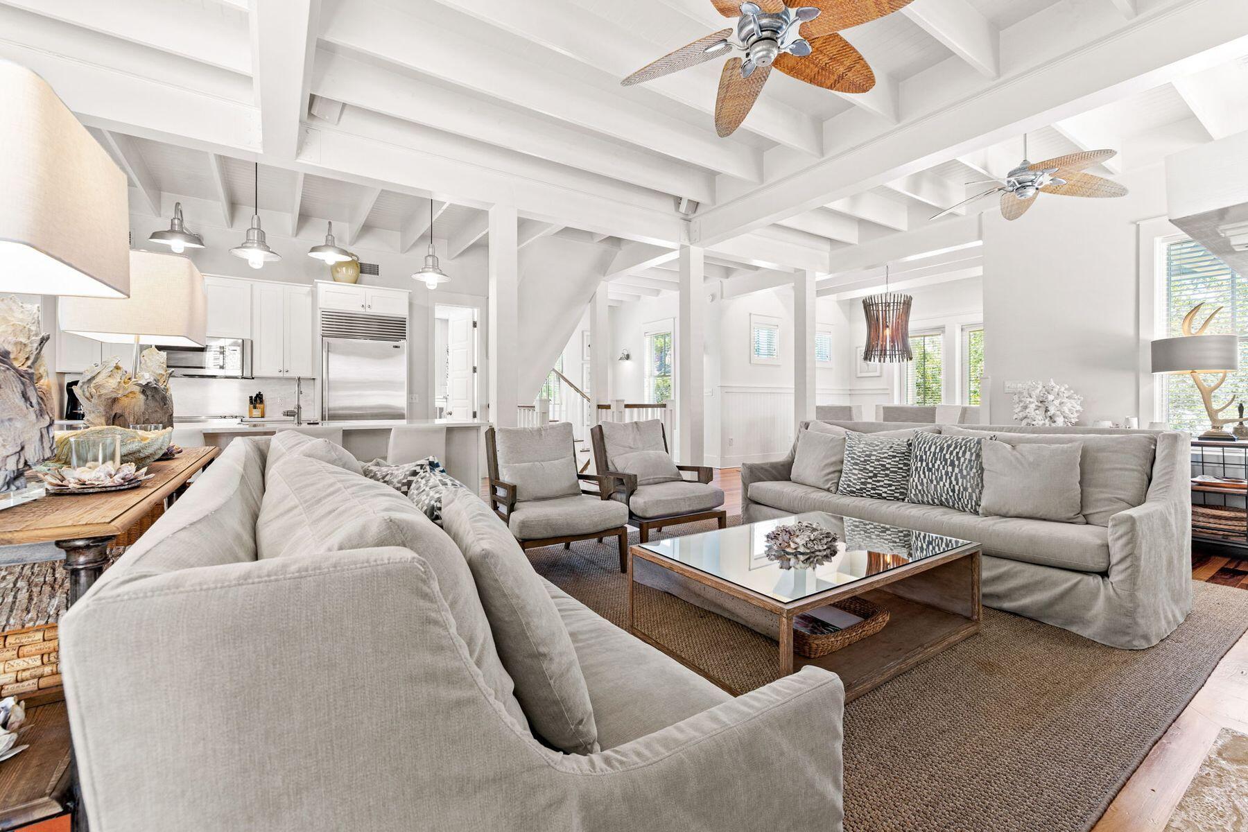 Buffered by greenery, this luxury Florida cottage in WaterColor Phase I sits on a private corner lot. From the covered front porch, it's a short walk or golf cart ride to the beach, private beach club, the boat house and walking trails. Outdoor living is what this home does so well with space to add a pool in the backyard. Four spacious porches, some screened-in, create a haven for laid-back outdoor living. Three floors of fabulous living space include two master suites, one on the main floor and another enjoying superb gulf views from its third-floor location. Three additional bedrooms and a bunk room welcome overnight guests when entertaining family and friends. This home features 5 owner's lock-up closets and every bedroom has a walk-in closet. Hardwood flooring and recessed lighting highlight each beautiful living space. On the second floor, the open family room includes a gourmet kitchen, updated in 2021. Heavy beams look down on sleek quartz countertops, new high-end stainless appliances and a Sub-Zero refrigerator. The adjoining bar is ideal for sharing snacks and cocktails before dinner, while a cozy breakfast nook is a great place to start each day. Enjoy family celebrations and entertaining in the dining room before relaxing in the comfortably furnished living room. The feature gas fireplace is flanked by built-in bookshelves and cupboards. Windows look out onto a leafy backyard with a paved barbecue terrace and room for a pool, pending approval. Additional features of the home include five owner's closets, a new water heater, a central vacuum system, surround sound and a spacious laundry room with ample storage. A carport and paved driveway provide ample parking. Room for a small pool where the outside terrace in the back is located.
This beautiful beach house is just two blocks from the private beach and sparkling waters of the Gulf of Mexico. Upscale WaterColor amenities include a spa, fitness center, tennis courts, six resort pools, golf, dining and a lazy river in Camp WaterColor. Seaside, Florida's, pretty restaurants and shops are just minutes away. 