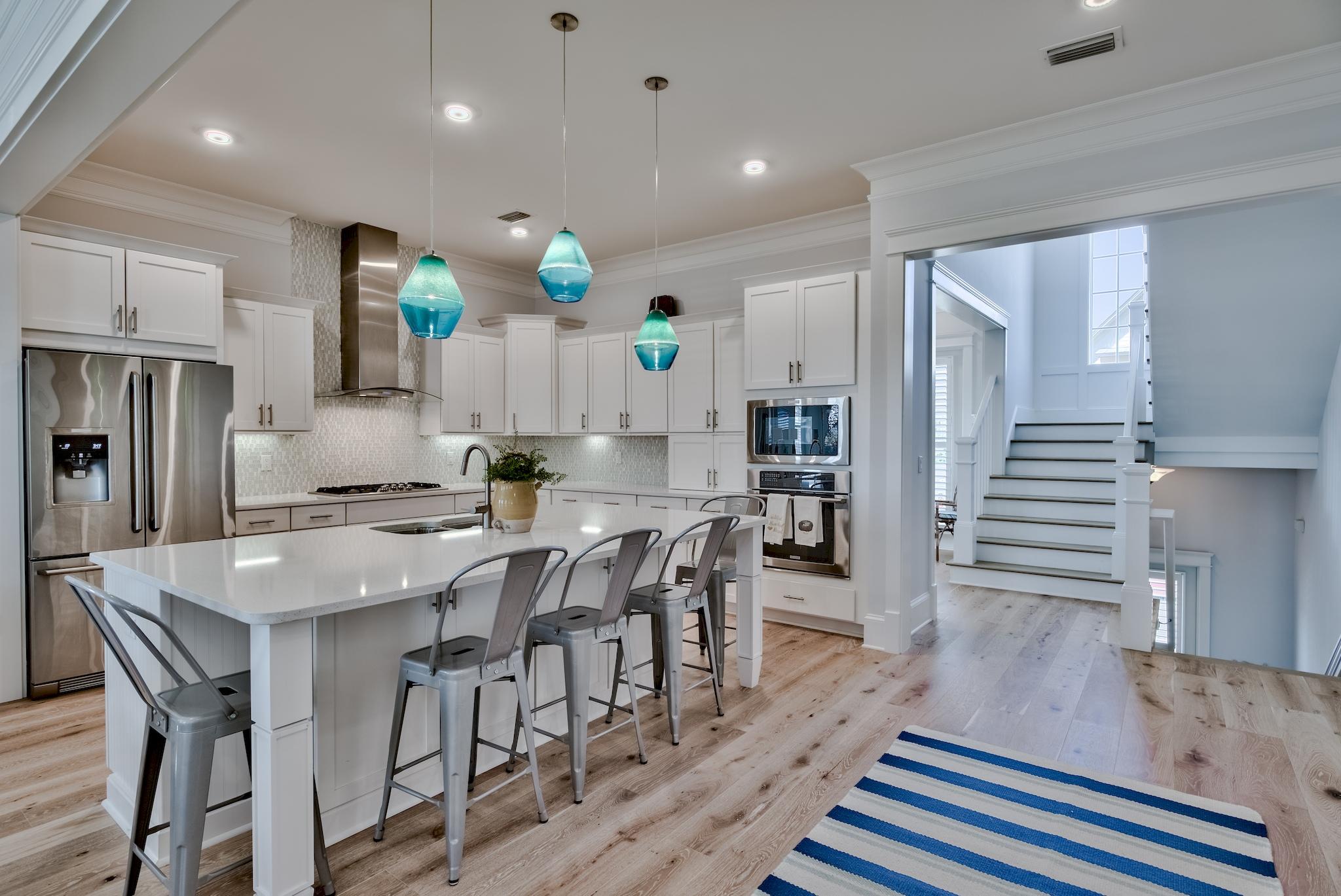 Welcome to the largest and only Key Largo floor plan available in the highly desirable community of Prominence, South of 30A. Built in 2017, this coastal elegant estate boasts 4243 sqft showcasing 5 bedrooms, 6 bathrooms multiple covered decks and a 2 car garage. Two living spaces, first floor could act as a bedroom ensuite giving this home six bedrooms.The kitchen features custom white cabinetry with soft close doors, under cabinet lighting, stainless steel appliances,