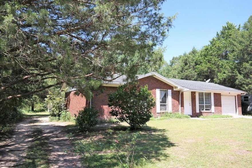 Modern, updated remodeled 3 bedroom, 2 bath brick home on approximately 1/3 acre just inside the city limits of Defuniak Springs. FL. Walk into a surprisingly spacious living room with generous dining area and past the breakfast bar to the bright, stainless steel kitchen. Walk on over beautiful, commercial grade hardwood floors and tiles in both bathrooms. From the serene street, drive up the paved driveway to the garage with access directly into the house. Inside, follow the hall with brand new carpet to the modern painted bedrooms enjoy sliding glass doors that open to the generous back yard with access to the storage building. This one is in a great school district and inside the city utility district...won't last long .