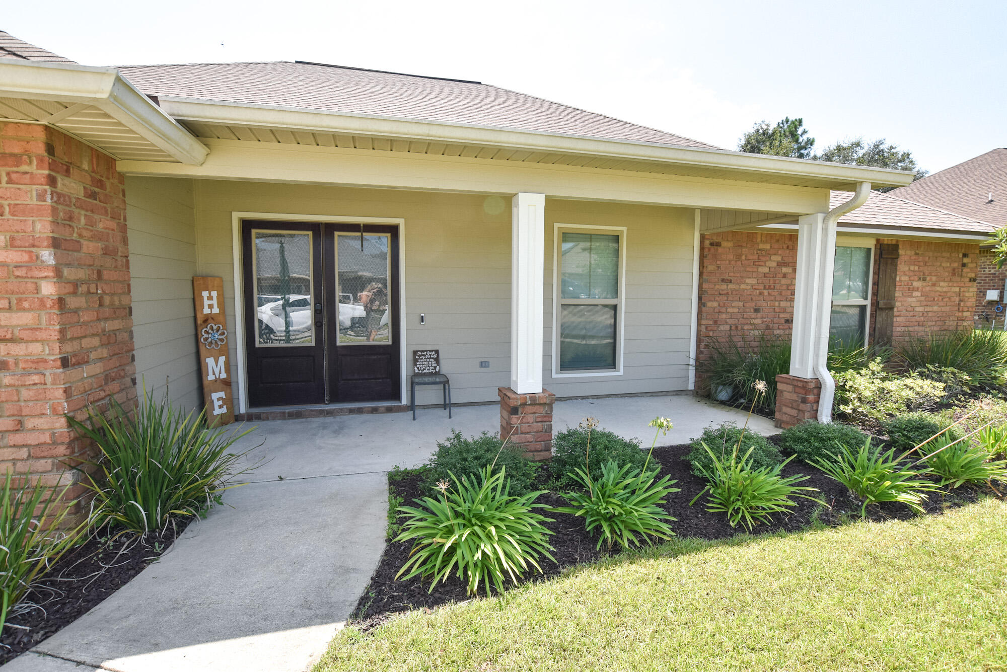 Brick 4 bedroom home located in the gated community of Chanan Estates. Spacious, split bedroom open floor plan with lots of room to spread out. Stone countertops with beautiful cabinetry, stainless farm sink, pendant lighting, and breakfast bar island for added kitchen workspace, with separate pantry and powder bath leading to the garage. All bedrooms have walk-in closets. The master bath has a separate shower and garden tub. French doors open from both the dining area and the master bedroom to the back porch. Built-in cabinets in the laundry room, and a 2nd!!!! laundry hook-up in master bath which can serve as a 2nd closet. The large backyard (1/3 acre) has room for everything...a grilling area with pavers is located off the porch, and the play set is included! Sellers installed