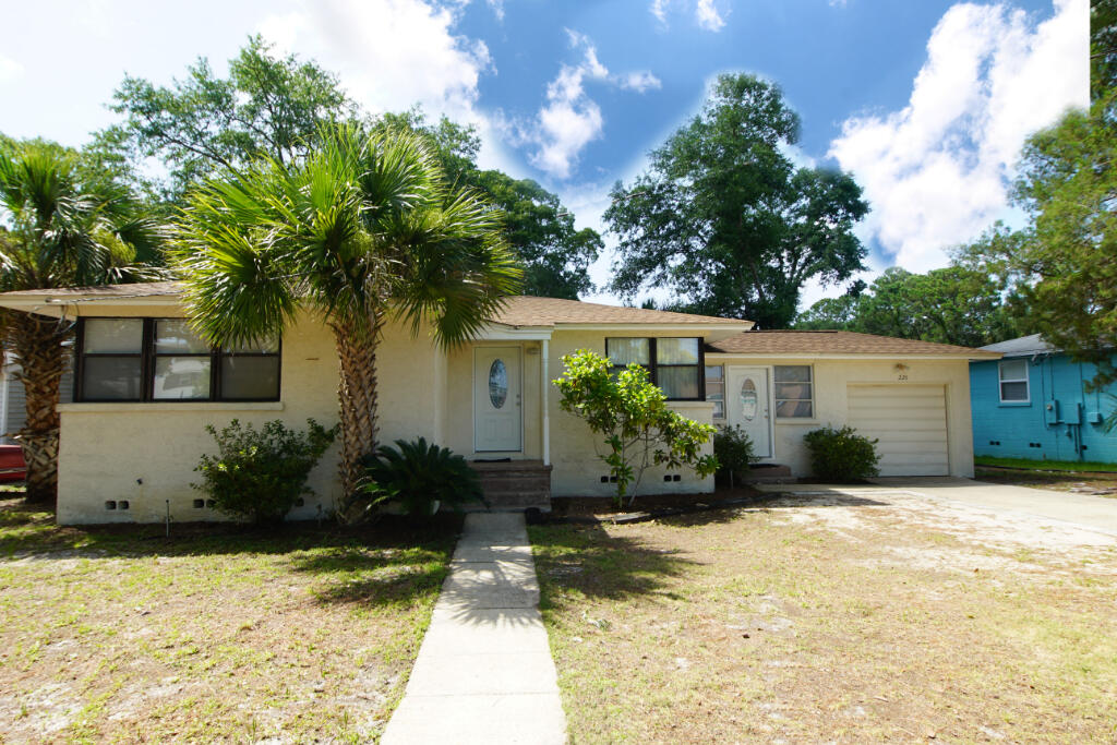 Beautiful two bedroom one bath home with Florida room and large separate laundry room. This home offers an attached garage with a completely private back yard situated across from the bay in an excellent location! The HVAC was replaced in 2019 and the hard wood floors have been professionally refinished. There is a gas stove and an extra large gas water heater. The back porch is covered and there are access gates on each side of the house. Garniers Beach is a very walkable and enjoyable neighborhood with a beach park a short walk from home. Short distance to everything, this is a must see!