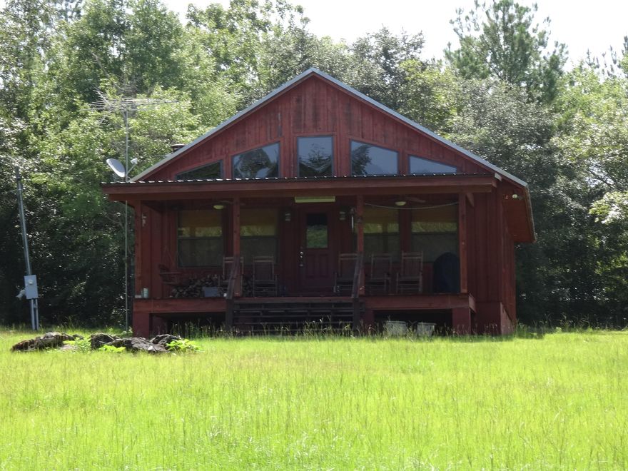 County Get-a-way or Hunter's Paradise. 240 acres with cypress pond full of ducks. Hunt deer, wild pigs, turkeys and more. Walk-in cooler, Covered picnic area, small stable with fenced-in pasture. Shooting houses, ladder stands, electric feeders. Food plots planted each fall. Country house with cypress walls inside and outside. Pine floors and ceilings. Included washer, dryer, refrigerator, furnishings included. Not included: Cookware, plates, silverware, personal stuff. Seller is Real Estate Broker.