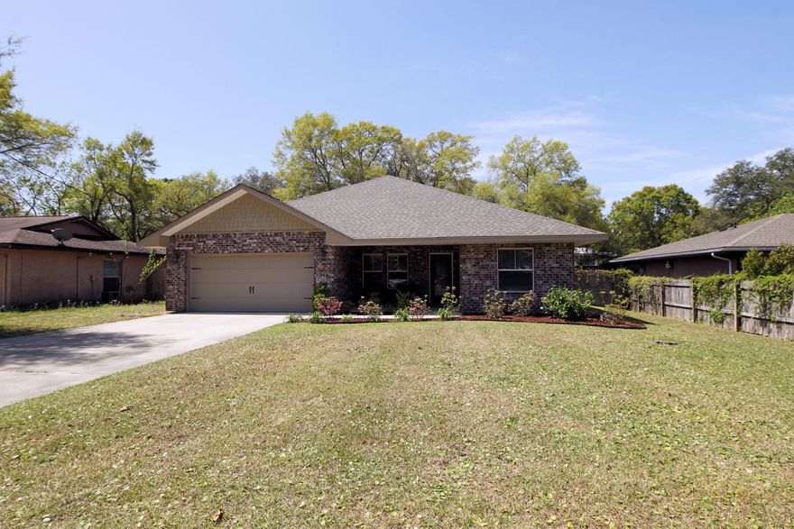Awesome floor plan!!! This 4/2 custom brick home has super curb appeal. There are 10 ft. ceilings w/ impressive crown molding, hand scraped Brazilian hardwood flooring, and 5 1/4'' baseboard throughout the main living areas. As you approach the front of the home, you will be quite impressed. The covered porch is very welcoming, and the incredible leaded glass door makes for a grand entrance. The formal dining room is at the left of the home's front. You will then enter the chef's delight kitchen which boasts maple cabinetry, granite counter tops, a pantry,water purifier,stainless appliances, including an OVERSIZE commercial grade frig/freezer! At the right of the home's entrance is bedroom one and two, continuing down the hallway is the guest bath, then bedroom three.