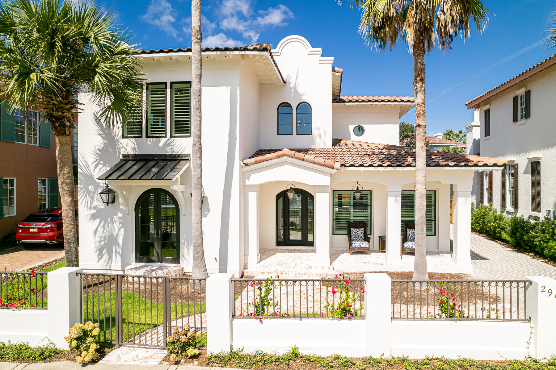 Ultra-luxe renovation/expansion just steps from the private beaches of Caribe. No expense was spared in fully updating this 4 bedroom, 4 and a half bathroom modern Caribbean style home where interior details include whimsical tile, built-ins galore, stunning architecture, and edgy custom lighting. Every surface was improved, beginning with a brand-new roof, and impact rated windows and doors. A tour of this home will leave you wondering, 'how did they think of that?' Custom-patterned pavers lead to a deep front porch overlooking sparkling lake views. A newly constructed private garage is wide enough for parking, beach toys, and your own golf cart. It even boasts its own commercial-sized ice-maker and custom cabinetry. The open-concept main level offers simply breathtaking detail from