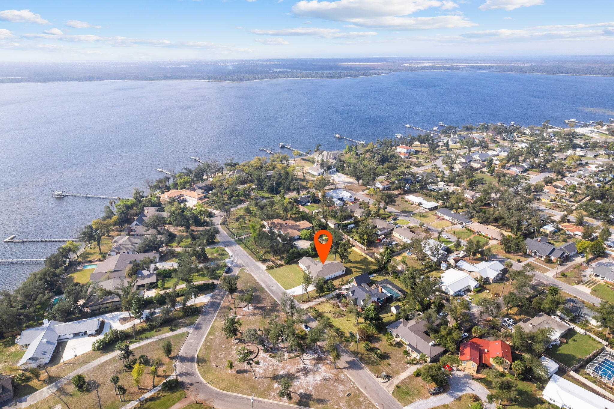 An incredible opportunity own a home with water views of the Bay on nearly a half acre in the Cove. This homesite sits across from a neighborhood park and has been completed renovated down to the studs and had almost 1,000 SF added to the home. This home was designed for a true split floor plan to include a 500 SF master suite with vaulted ceilings, private covered patio, marble tile floors and shower in the en suite as well as an oversized walk-in closet. The vaulted living room features a shiplap fireplace and double French doors leading to the covered patio and incredible back yard with hundred year oak trees. The kitchen was expanded and offers custom griege cabinetry, GE Cafe appliances, natural gas 5 burner range and an unbelievable amount of pantry space.