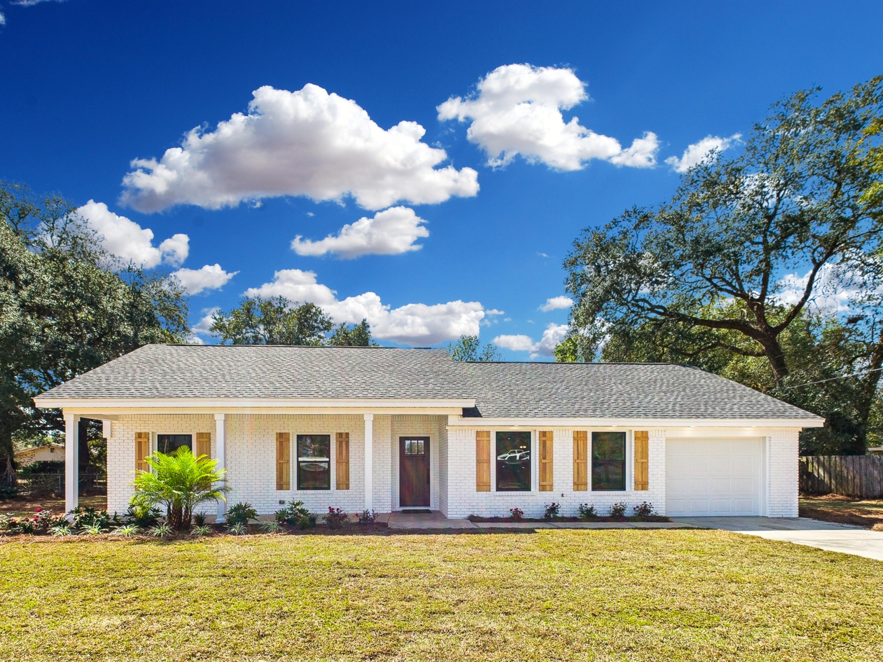 Completely Renovated Home with Modern Charm and No Stairs! Step into this beautifully reimagined home, completely renovated down to the studs, offering a new effective year built of 2023. Thoughtfully designed with a split floor plan featuring two master suites, this single-story gem is move-in ready. The primary master suite boasts a dual vanity, soaking tub, separate walk-in shower, and a spacious walk-in closet, while the second master suite offers a sleek walk-in shower--ideal for guests or multi-generational living. From the inviting white brick exterior with natural shutters to the charming front porch, perfect for rocking chairs and morning coffee, this home blends timeless style with modern conveniences. Inside, you'll find new windows, matte black hardware, recessed lighting, and an electric fireplace with a raised hearth and mantle. The heart of the home is the designer kitchen, featuring pendant lighting over a large island with deep drawers, a breakfast bar, and ample storageincluding floor-to-ceiling pantry cabinets. A French door refrigerator and stainless steel appliance package complete the space. Additional highlights include a garage with epoxy floors and opener, pull-down attic stairs, tankless water heater for endless hot water, indoor laundry room with a drop zone and a freshly sodded yard for easy outdoor enjoyment. This home offers modern luxury with no detail overlooked. Schedule your private tour today!