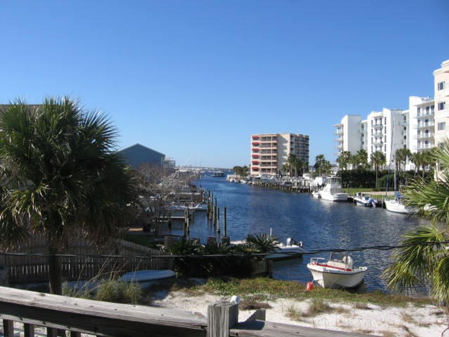 This Holiday Isle town home is located on the Destin Harbor/Canal. This unit is a 2 bedroom, 1.5 bath with living area, dining area, kitchen and features a Florida room overlooking the Destin Harbor. Holiday Isle has access to two private beach accesses and one public access all of which are within a short stroll of the home. The home was completely remodeled in 2004 to include walls, carpeting, kitchen cabinetry, and appliances. The metal roof was replaced in 2004 and the Florida room windows were replaced with hurricane resistant panes that can be opened and are screened which makes the room usable year round. Sit on the lower or upper deck and enjoy the beautiful Florida sunsets. This home is being sold 'As is' and priced accordingly. These units do not have boat slips.