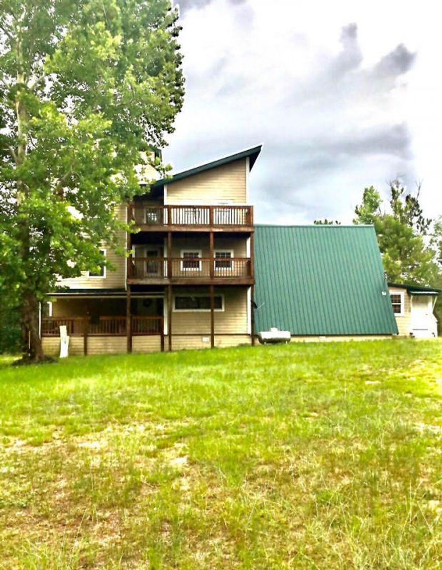 Searching for a new home ?  What about your very own country condo nestled within five acres? Located near Florida's beautiful beaches, Elgin Air Force Base and wonderful shopping malls. You don't want to miss this uniquely built house. First floor has huge living room, beautiful kitchen and dining room with plate glass windows, and spacious bathroom. Going up the stairs you will find two nice bedrooms, one with big windows to enjoy the view. Taking the stairs to the third floor you will find the master bedroom suite with walk-in closet, newly renovated bathroom, and two 4x8 windows overlooking the property. The fourth floor finished attic could be used as a 4th bedroom or extra large storage area, exercise room or even a nice office.