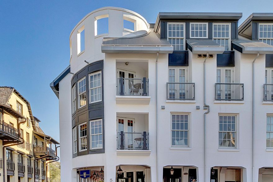 GULFSIDE IN ROSEMARY BEACH, A CORNER, 3RD FLOOR CONDO WITH LIGHT, LIGHT, LIGHT WHERE CITY MEETS THE BEACH! A recent renovation by Architect George Israel WOWS from the entry Foyer to the oval shaped Living Room flowing east to the Master Bedroom wing and southwest to the Kitchen/Dining/Keeping room. (A Keeping room is a smaller sitting area located near the kitchen where one may keep the cook company). The Guest Bedroom with en suite Bath also occupies this wing in a split floor plan (see the floor plan). Five (5) separate balconies wrap the outer perimeter of the Condo such that every room enjoys a view to Barrett Square. This Rosemary Beach Town Center location is especially wonderful when events are hosted allowing a front row seat to all that is happening.