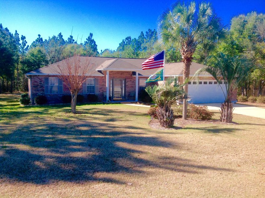 Charming, country home on an acre of land that is within minutes of Crestview. Lovingly cared for, this beautiful home has an open floor plan with 3 full bedrooms and an office which is large enough to make into an additional bedroom. Spacious family room with a corner gas fireplace for those cool Florida evenings and sliding glass doors that lead out to the covered deck. Kitchen has solid surface counter tops a hop-up eating bar and over looks the family room. The master bedroom has an extra large closet and plenty of room for all your bedroom furniture. This is a a split bedroom floor plan having two additional bedrooms and a hall bathroom. HVAC system only 3 years old. Laundry room has a built in counter top and cabinets for your convenience. The back yard is unbelievable,