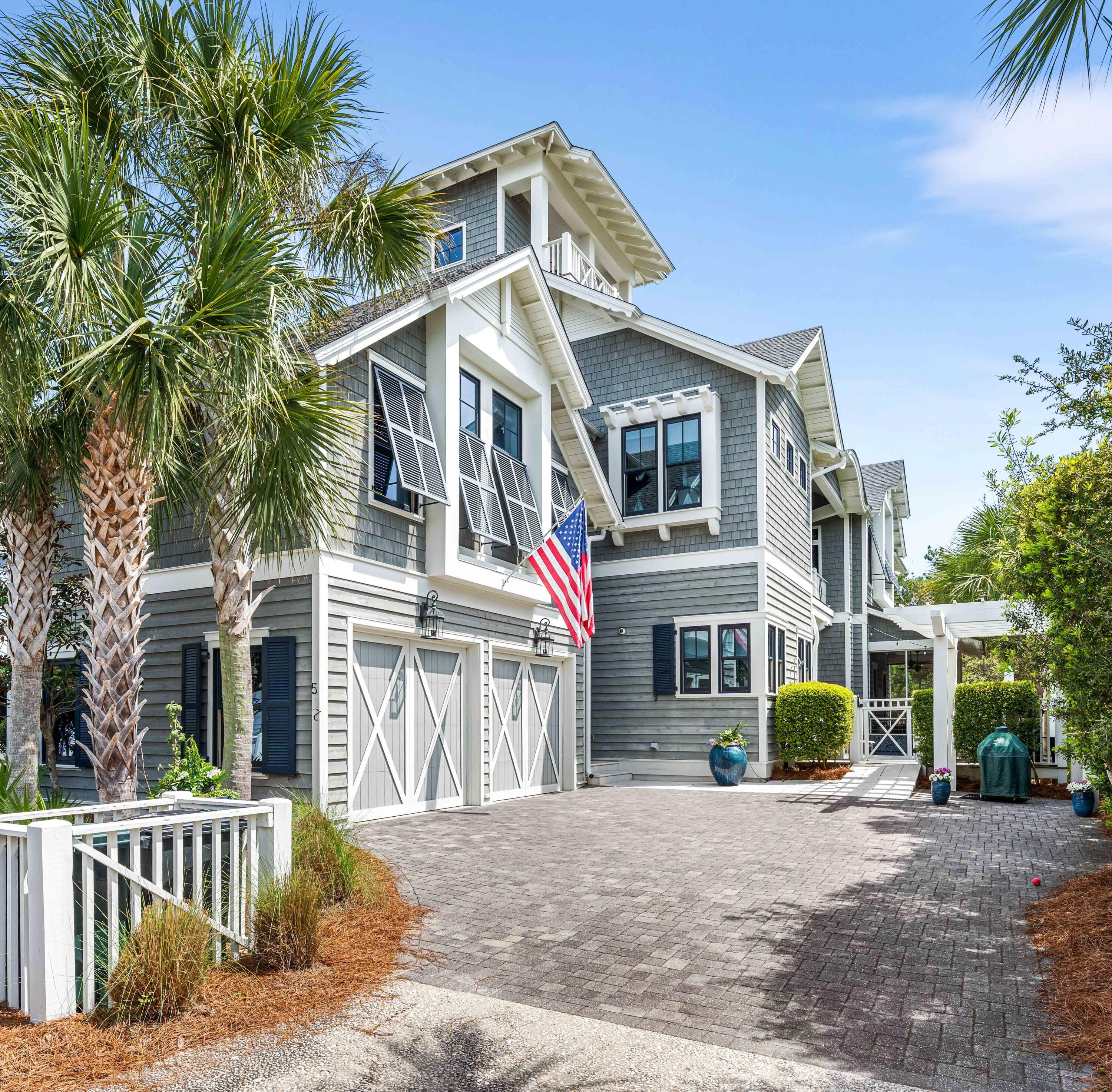 This gated coastal retreat in Watersound Beach is absolutely stunning! The home boasts 6 bedrooms and 5.5 bathrooms with elevator, offering ample space for both relaxation and entertainment. Built by Dunes Construction and decorated by Beau Interiors. The living, dining, and kitchen areas flow seamlessly together with high beamed ceilings perfect for hosting guests or enjoying quality time with family. A chef's dream with top-of-the-line appliances including a Professional Wolf gas range and sub-zero refrigerator, along with custom cabinetry and a spacious island for meal preparation and gathering. The backyard features a sparkling heated pool, ideal for lounging and dining al fresco, surrounded by lush landscaping and privacy fencing for a serene atmosphere and great space for your pets.