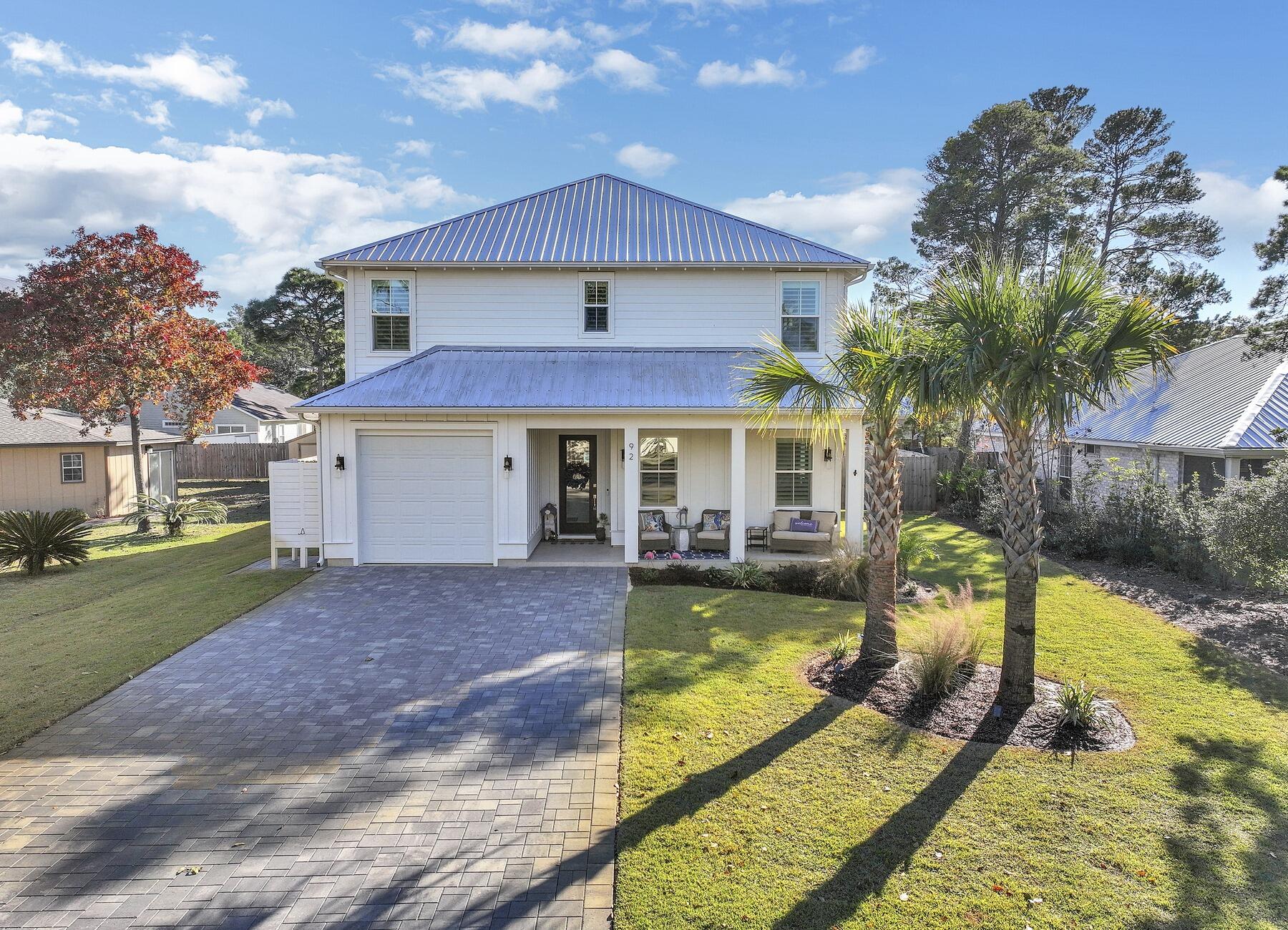 Welcome to ''30A Coastal Retreat'' - 92 Woodland Dr is a home you must see if you are on the market today. 2 Master Suites, one on each floor, 2 Guest Bedrooms with Jack and Jill bathroom on the second floor, large fenced backyard with an outdoor living area, modern summer kitchen perfect for entertaining and well appointed salt water pool for your ultimate beach house living and experience. 10' ceilings, beautiful flooring, custom finishes and details throughout combined with a cozy coastal decor and furniture sets this home apart. Some of the features include, shiplap walls, waterfall kitchen island with a 3 cm quartz countertops, white shaker cabinets, SS appliances, 36' gas range, marble tile backsplash and more. The living room offers the perfect dry bar with wine fridge and