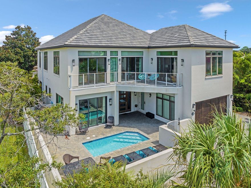 Welcome to 119 Avalon Blvd! This perfectly positioned 6 bedroom, 6 bath home boasts beautiful views of the Gulf Coast's emerald waters. Thoughtfully constructed to maximize livability, each step through this property will continue to impress. Contemporary in design, this 4000 sq ft iconic residence features a professionally decorated interior, spacious pool deck, attached cabana room complete with full wet bar, and a custom bunk room. Not to be outdone, the open concept 2nd level captivates with straight forward views showcasing crystal clear waters from both the living room and master bedroom. Avalon Beach Estates sets itself apart with  its exclusive private beach. Dedicated to just residents and guests, beachgoers can  take full advantage of the sugary white sand! Come visit!