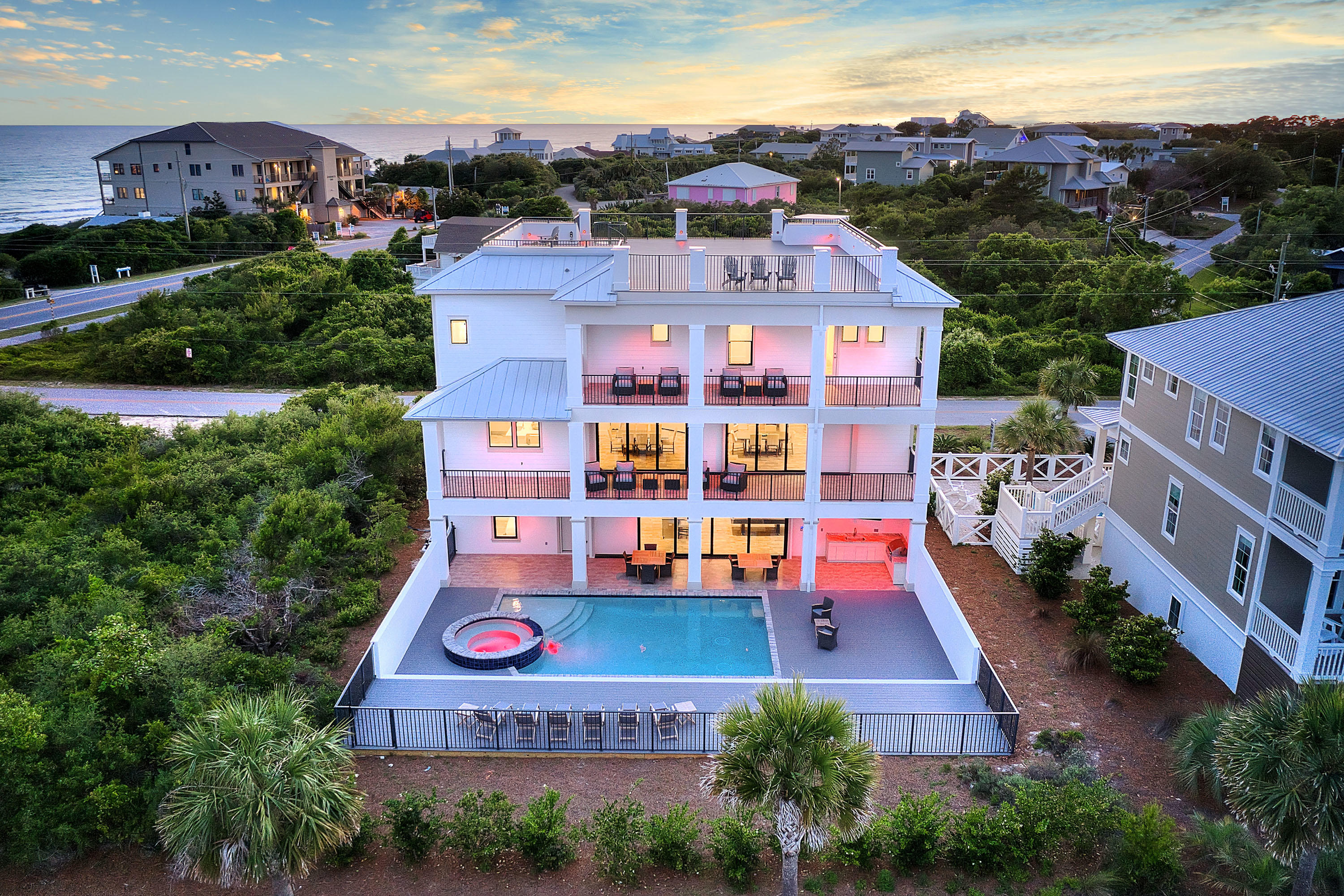 30A location and just steps to public beach access, this newly built home includes gulf views and rental success. Set to top $250K in 2021 vacation rental income, this stunning home features state-of-the-art amenities and a resort-style pool. This 2019-built, 5,688-square-foot home includes a designer kitchen and a rooftop viewing deck, in-home elevator, private pool, and game room. Each space is carefully curated for exceptional living and entertaining. White walls, clean lines, and coastal materials punctuated with sea-inspired hues make the rooms feel relaxed and airy while highlighting the natural beauty outside. The private resort-style pool, includes a spa, spacious deck, covered alfresco dining, and a summer kitchen, elevating the backyard to a gorgeous open-air oasis.