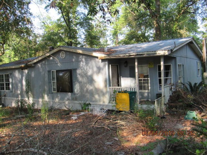 Do some repairs and make this mobile home your home on 3/4 acre in city limits of Ponce de Leon. Priced affordably to account for repairs needed. Property is being sold as is. Home has a a 15x12 addition on back that could be used as a 4th bedroom or den. Fireplace in LR. No HVAC system, needs TLC. Septic and city water.
