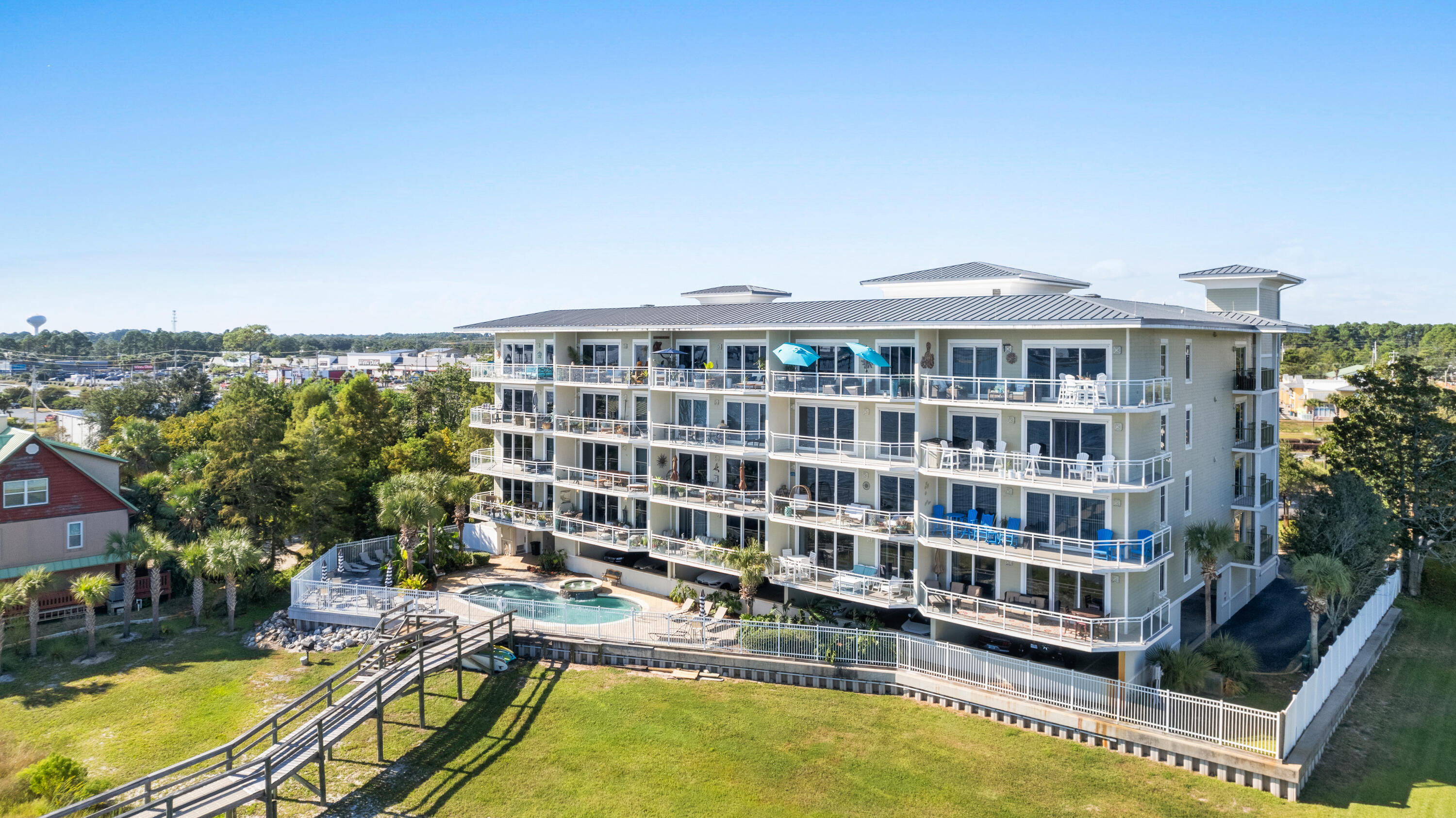 Come view the amazing sunsets at this three bedroom, three bathroom unit located on the inter-coastal waterway. This property is a gated 23 unit complex that each unit has a marked parking spot on the first floor parking garage. A boat slip for a maximum 26 foot boat and a climate controlled storage unit are included are also included in this listing. The complex is an easy walk or kayak trip across the inter-coastal waterway to Navarre Beach. Short term rentals are allowed and the location is in the Heart of Navarre close to restaurants, coffee shops and to many local retailers.