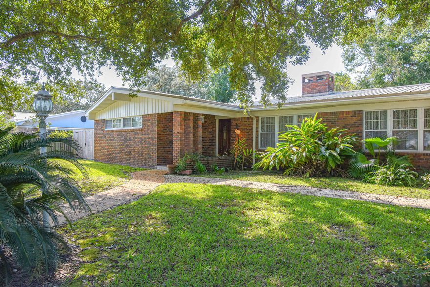 This large, charming, 4 bedroom home will take you back to the good ol days when there were formal living rooms, dining rooms and a large and open family room attached to the kitchen!  There is a dual fireplace that opens to both the Living Room and the Family Room.  AND... there is a bonus room with a cedar closet and a pull down Murphy bed. The 4th bedroom has an exterior door and bath (perfect for an in-law or young adult).  The HVAC was replaced approximately 4 years ago. Don't miss the wonderfully done Florida room where you can enjoy your morning tea/coffee... unless you choose to sit out on the patio in the shade of the oak tree as you enjoy the crape myrtles, camellias and azaleas.