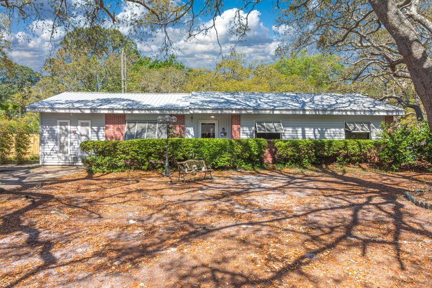 AS-IS sale of a solid Mary Esther home on a beautiful oversized lot. Gorgeous 100 year old Live Oak trees have created the most beautiful canopy over the property. The 0.36 acre lot is 195 feet deep at its longest and has a huge backyard. This home has been lovingly cared for over the years and is ready for a new owner to make it their own.  The interior is in its original state and full of vintage charm. It is a time capsule with all the original finishes and fixtures from the Art Deco Tiled bathroom in mint green and pink, to the wood paneling and shag carpet. The family believes there to be gorgeous solid wood floors beneath all of the carpet just waiting for someone to uncover them and bring them back to life.